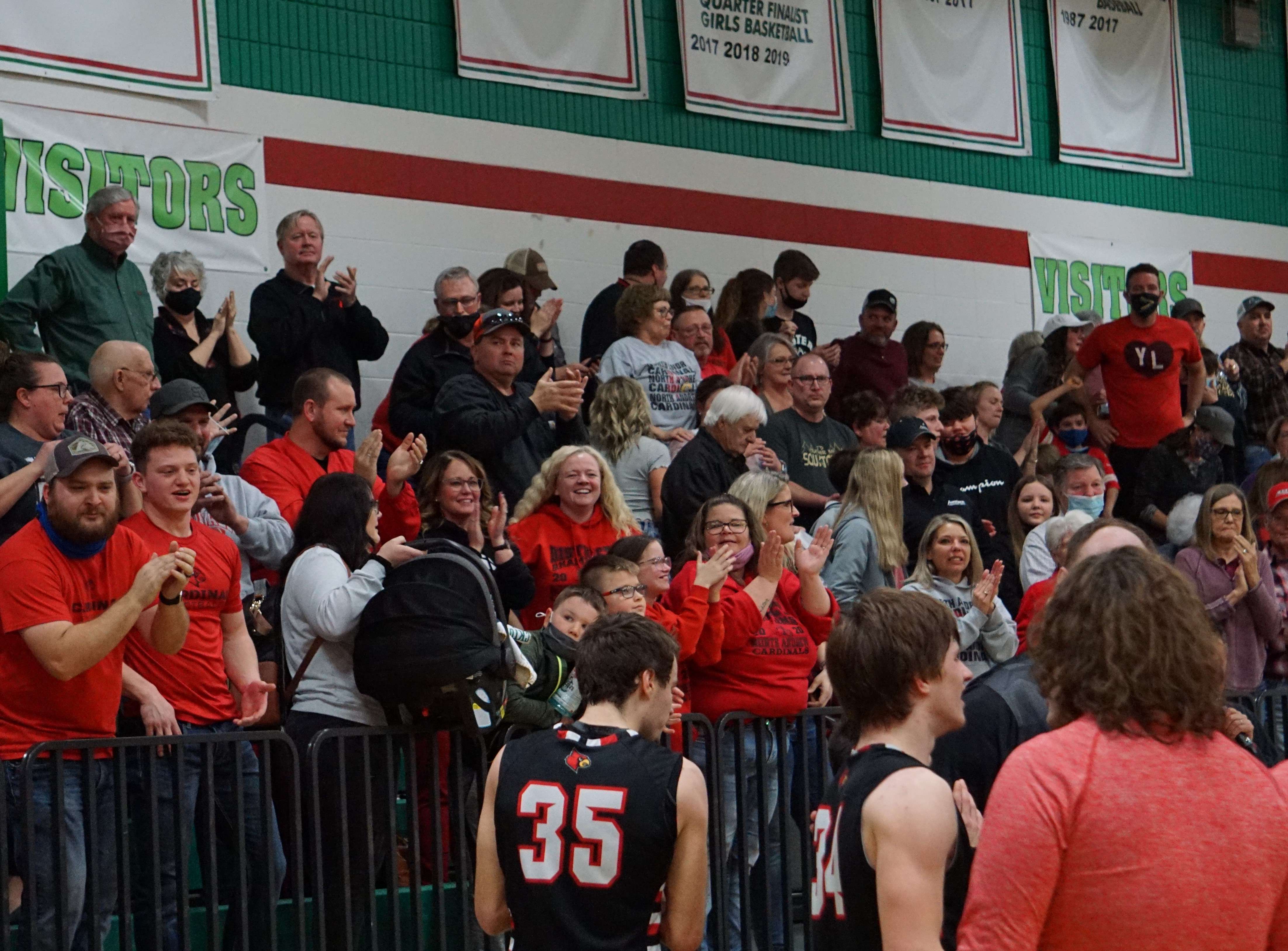 North Andrew fans who made the trip give their Cardinals a standing ovation after the 48-45 win over Mid-Buchanan Tuesday. Photo by Tommy Rezac.