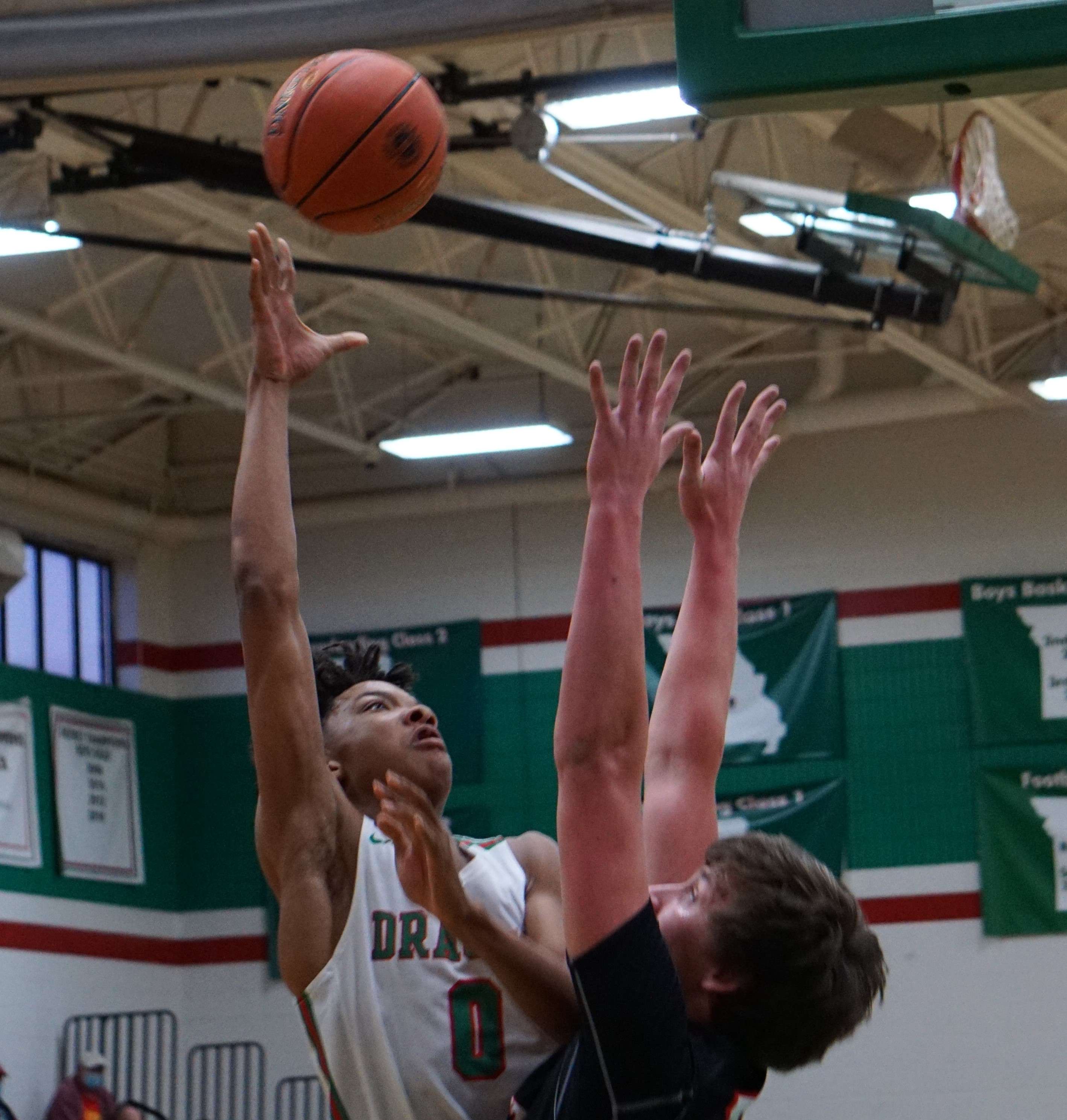 Mid-Buchanan's Joe Clark (0) goes up for two against North Andrew's Owen Graham in the first half of Tuesday's Class 2 sectional playoff game. Photo by Tommy Rezac.