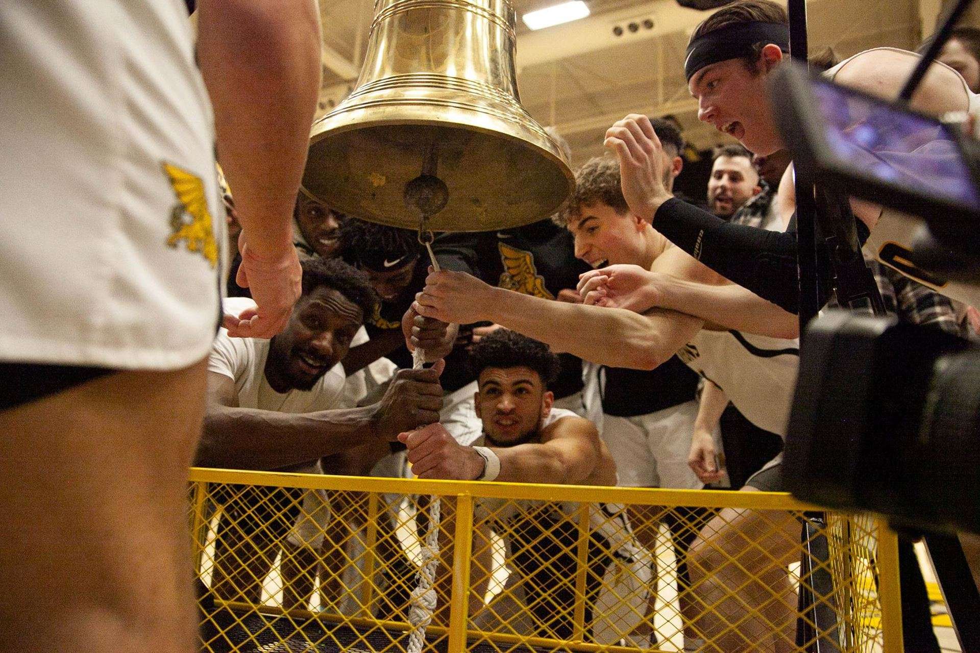 The Griffons ring the bell after an 84-76 comeback win over Lincoln in the MIAA quarterfinals at MWSU Fieldhouse Wednesday. Photo via GoGriffons.com.