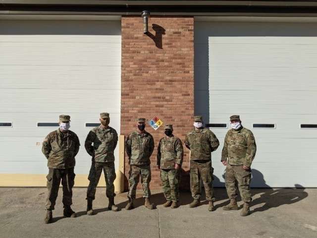 The Field Maintenance Shop 1 team takes a moment for a group photo outside of their maintenance bays in Hays Jan. 28, 2021. FMS 1 took first place at the National Guard Bureau for the annual Army Award for Maintenance Excellence in December 2020 in the Tables of Distribution and Allowances category. Pictured from left to right: Sgt. 1st Class Lyndon Ellis, Sgt. 1st Class Lance Jones, Chief Warrant Officer 3 Michael Schmidtberger, Sgt. Brandi Brooks, Spc. Theo Stone and Staff Sgt. Dennis Dinkel. Not present are Warrant Officer 1 Michael Murphy, Staff Sgt. Luke Pechanec, Sgt. Blake Slife and Spc. Jake Romey. (Photo by Staff Sgt. Jennifer Milnes)