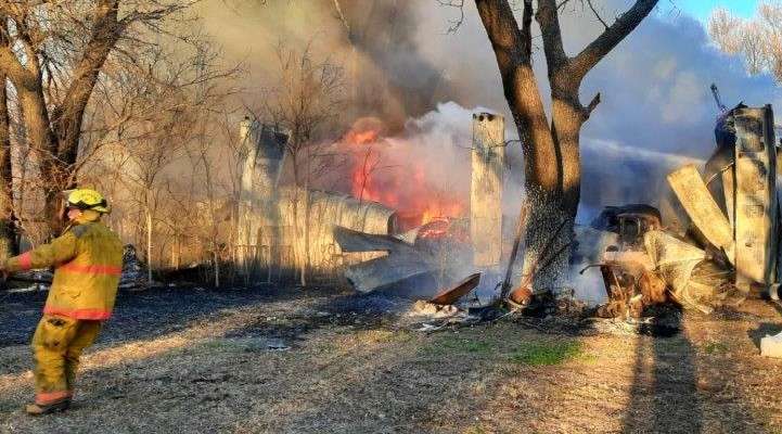 <b>What is left of some of the vehicles can be seen in the fire.</b>