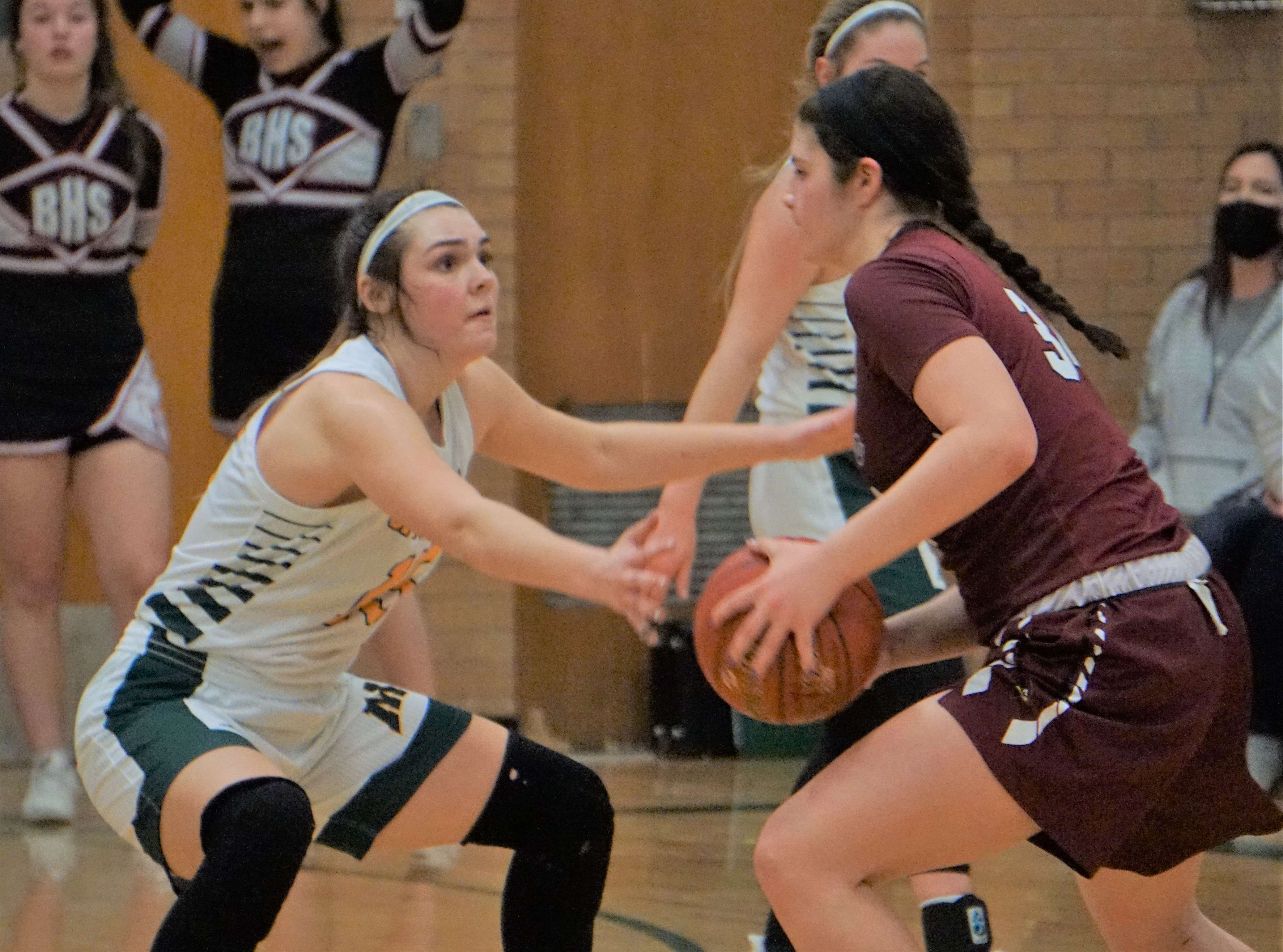 Benton's Kianna Herrera is guarded by Maryville's Anastyn Pettlon in the second half of the Cardinals' 45-40 win over the Spoofhounds Thursday. Photo by Tommy Rezac.