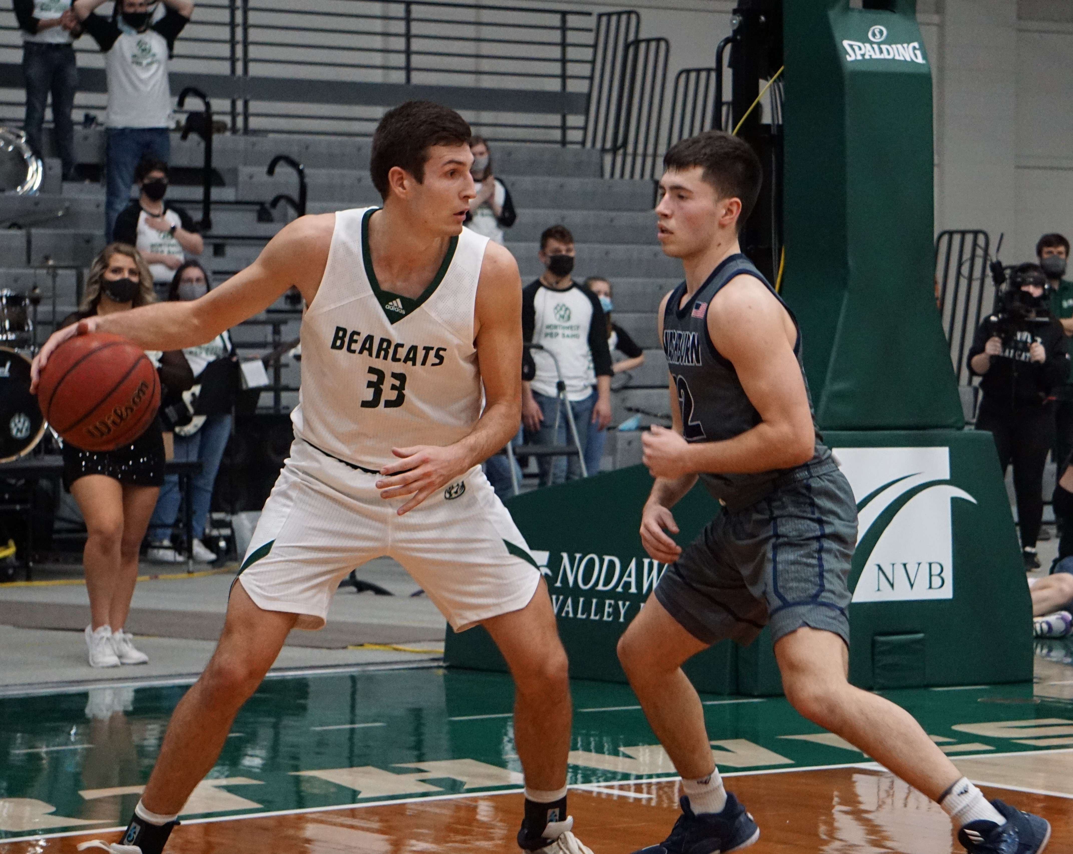 Northwest's Ryan Hawkins (33) tries to drive against Washburn's Tyler Geiman during the MIAA championship game at Bearcat Arena. Photo by Tommy Rezac.