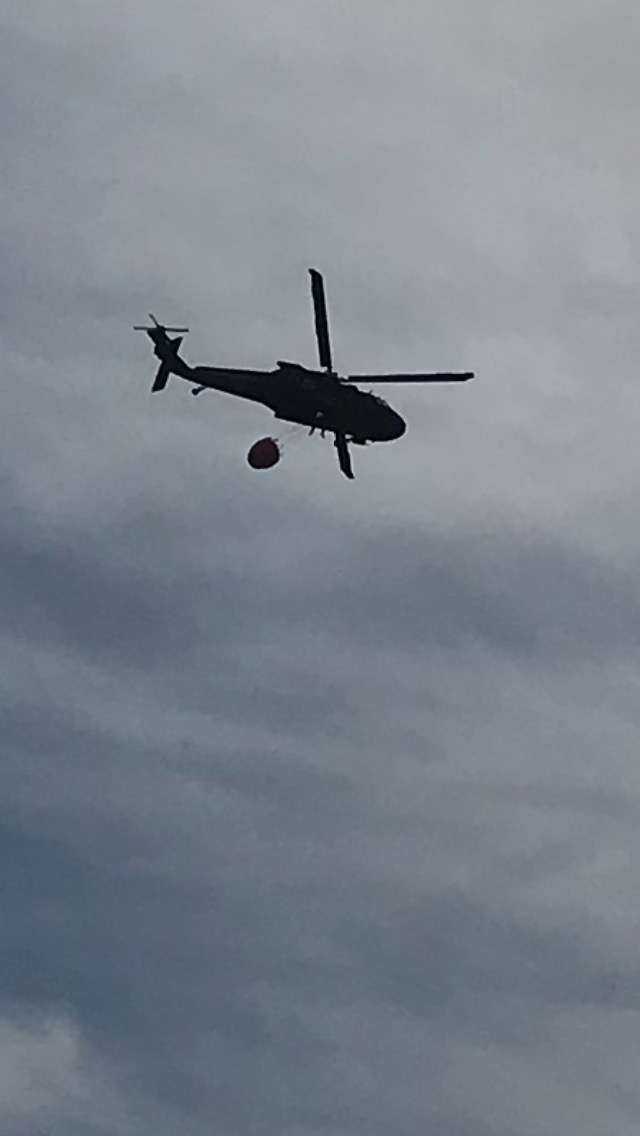 ( Photo - Garry Berges ) National Guard helicopter dropping water on the fire