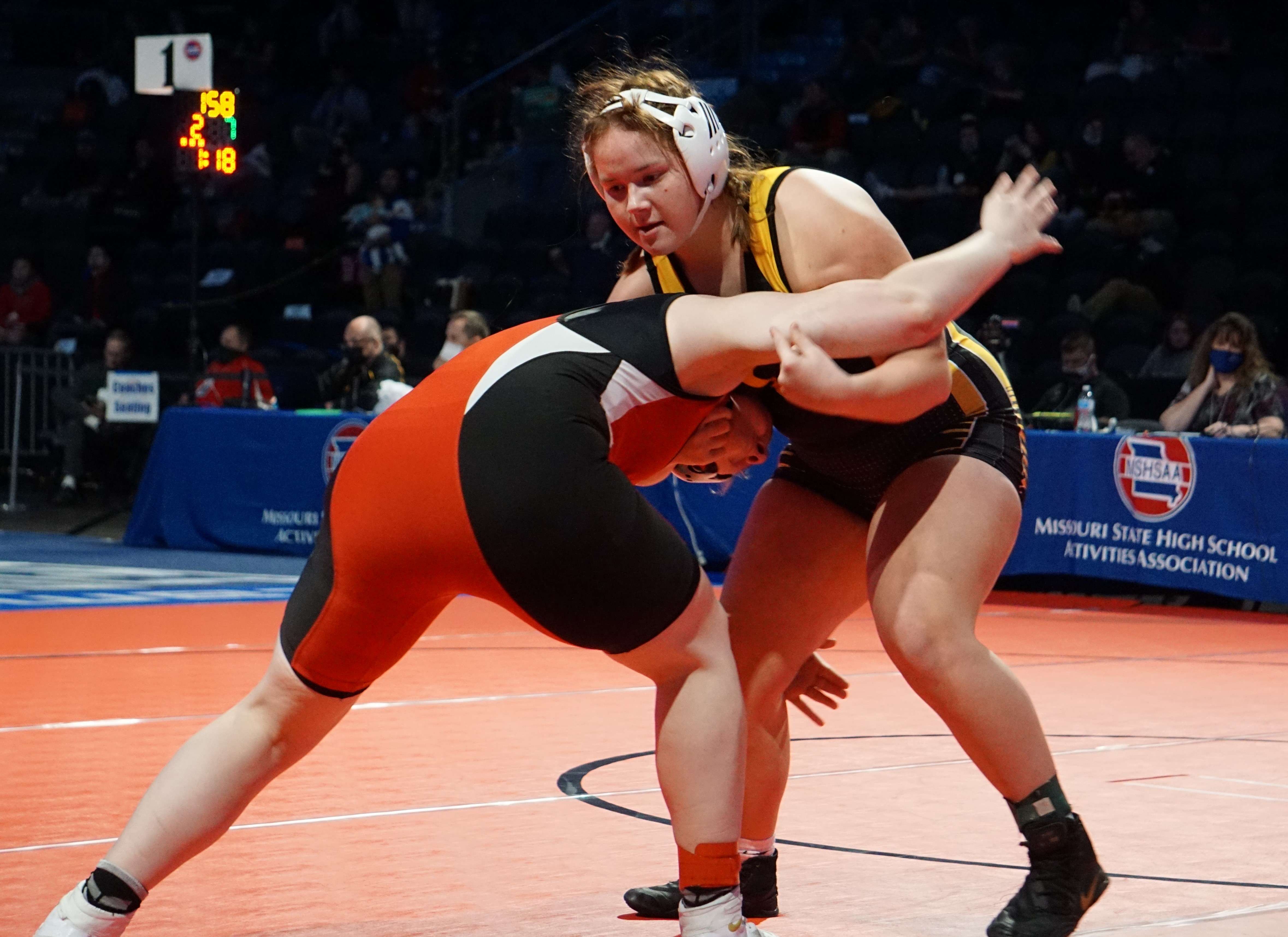 Cameron's Hollie Hedgpath (right) battles Lily Burns of Tipton in her second-round wrestleback match on Tuesday at girls' state wrestling at Cable Dahmer Arena in Independence. Photo by Tommy Rezac.