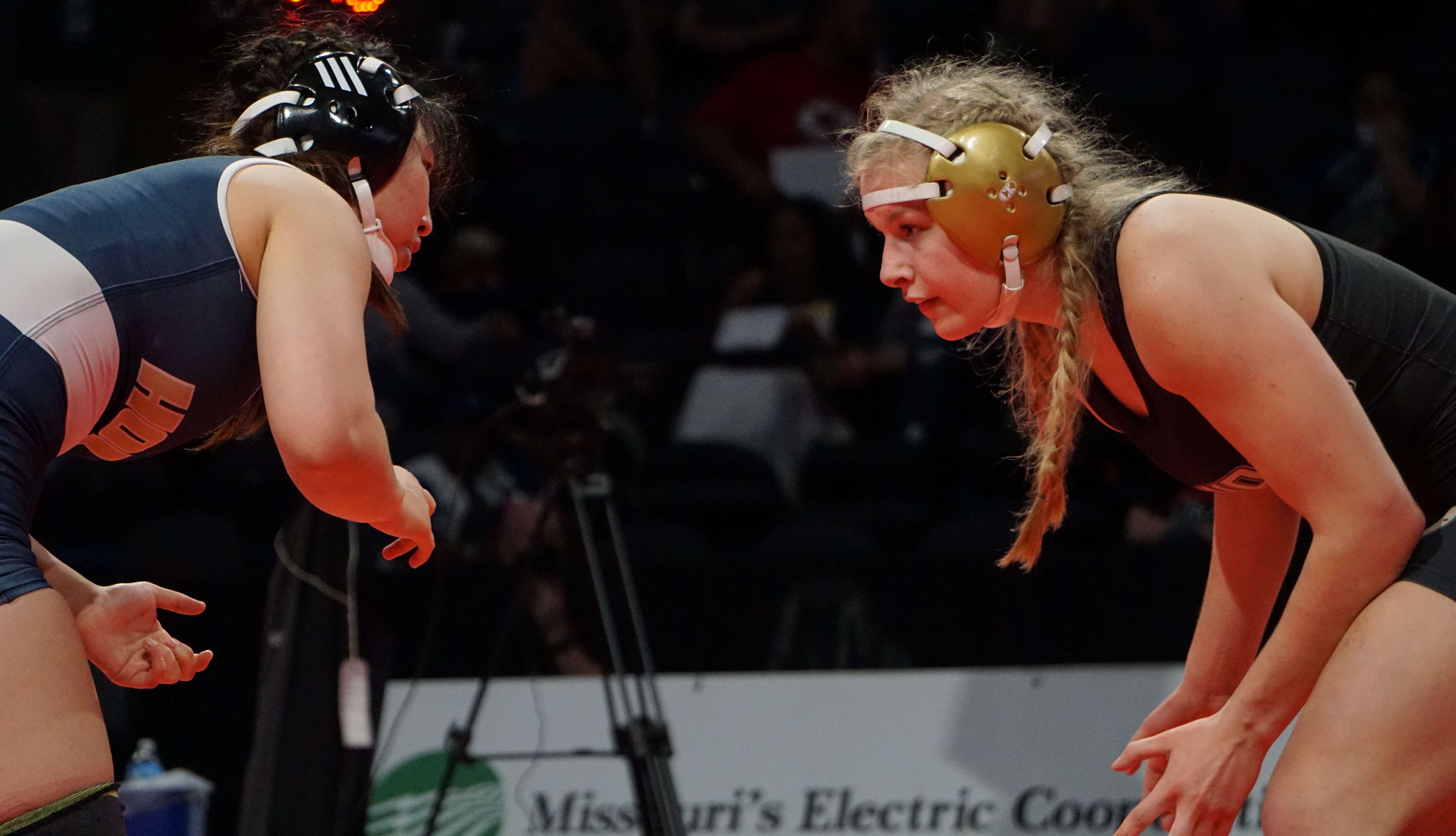 Josie Wright squares up against Esther Han of Holt in her semifinal match at girls' state wrestling Tuesday. Photo by Tommy Rezac.