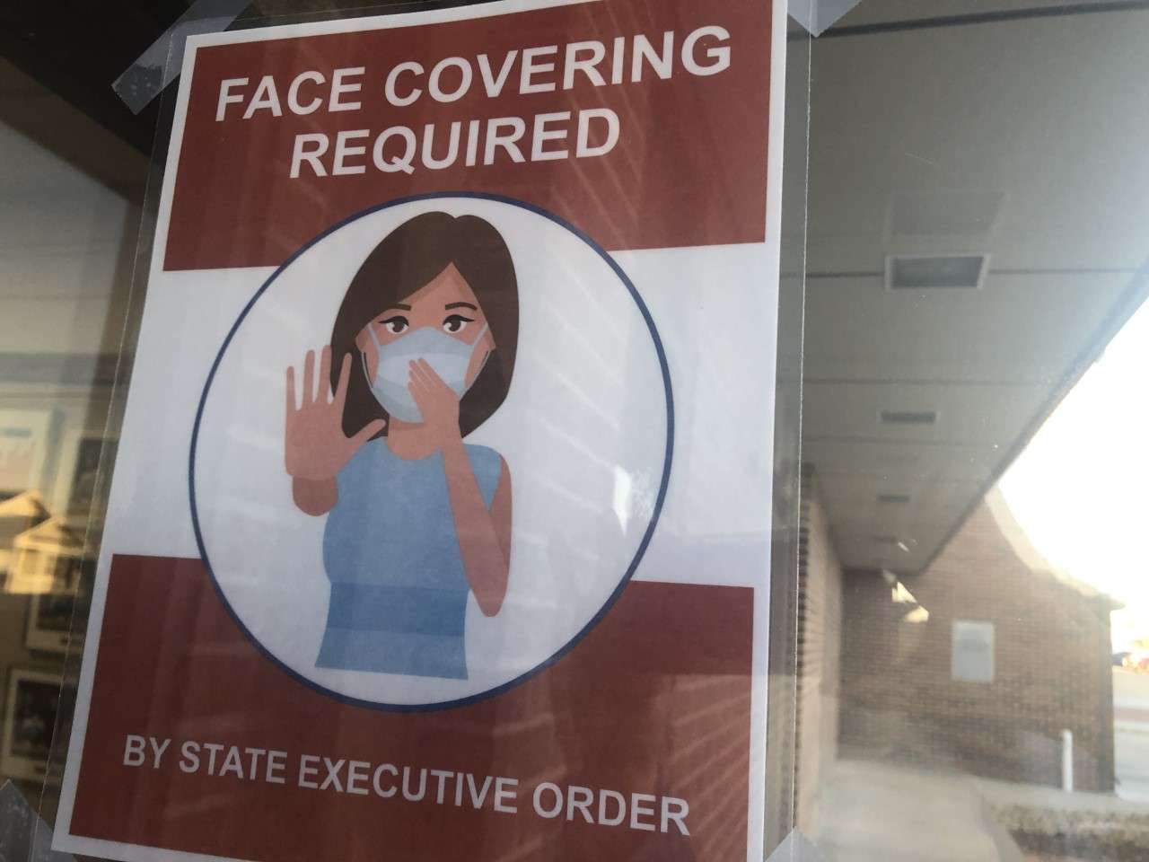 An updated&nbsp; poster on the door of Hays City Hall reflecting the expiration of the city face mask ordinance on Wednesday. The governor's executive order requiring face coverings in public entities continues through March 31.&nbsp;