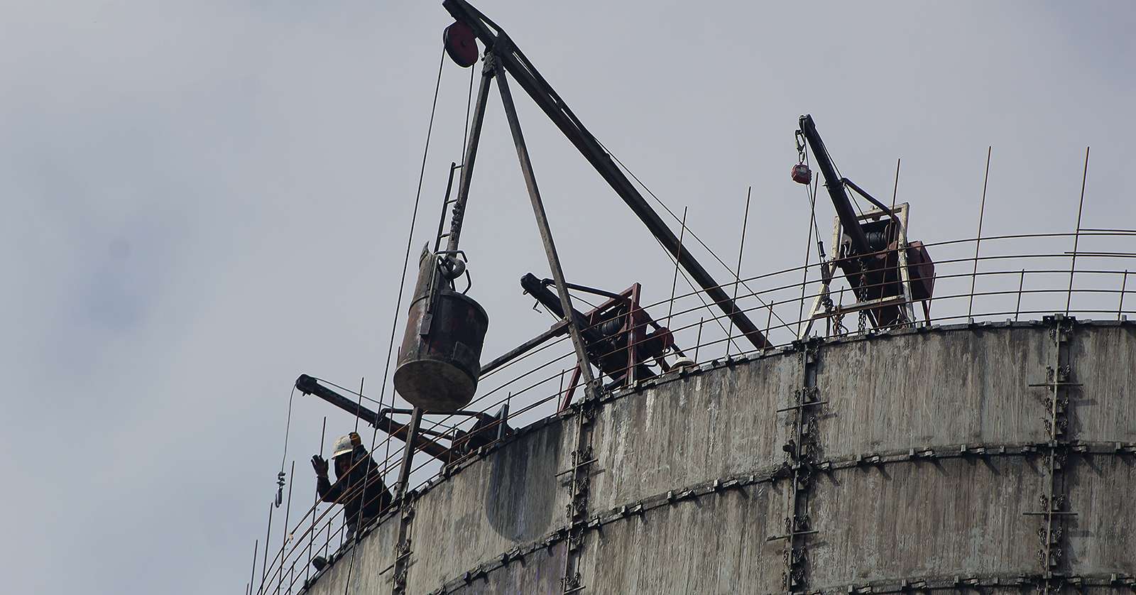 A worker on top of the second new grain bin at Midland Marketing's Toulon facility. Five new grain bins with a total capacity of 1 million bushels are being built at the site.