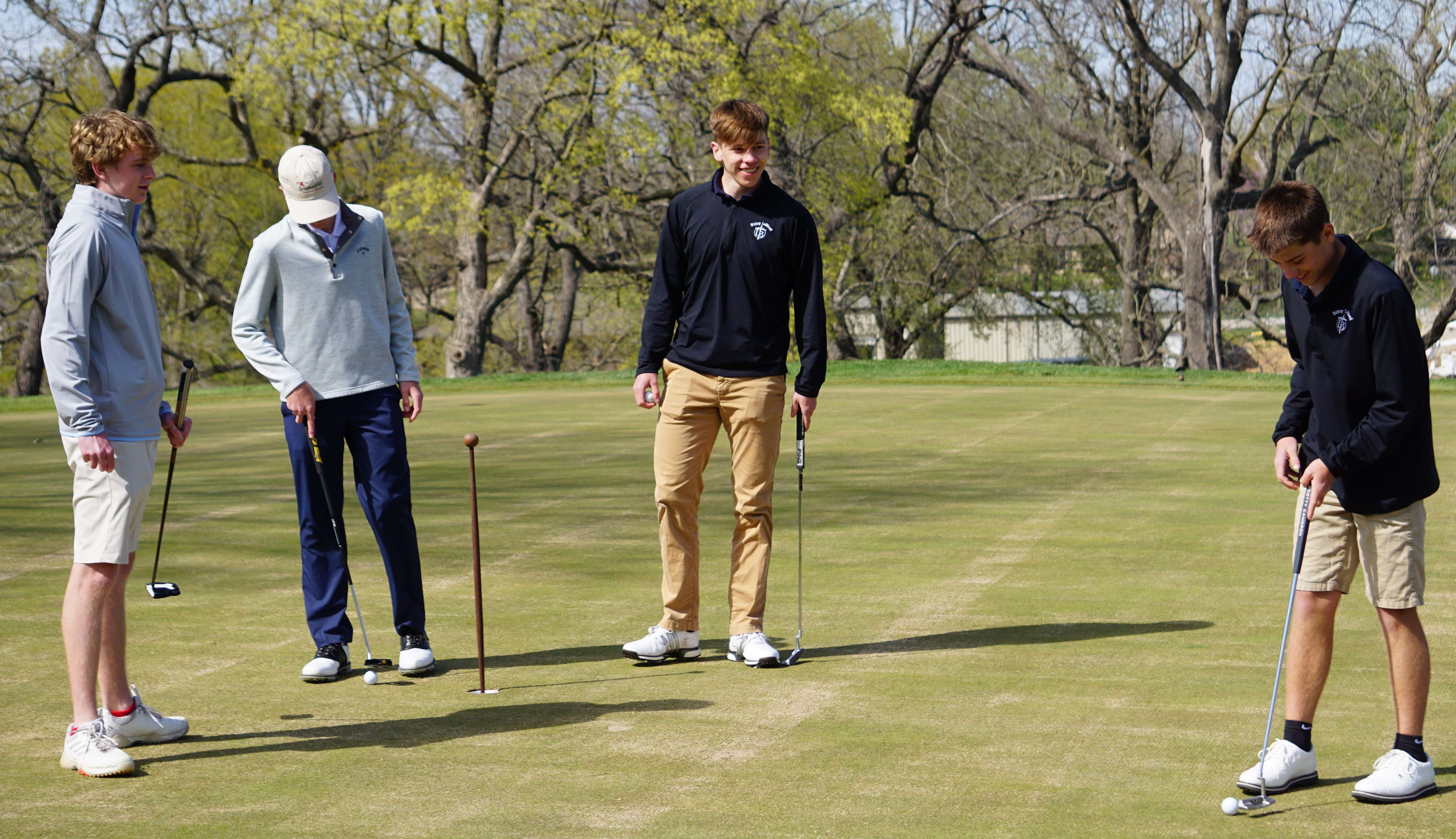 The Bishop LeBlond golf team practices on the putting green at St. Joseph Country Club. Photo by Tommy Rezac.