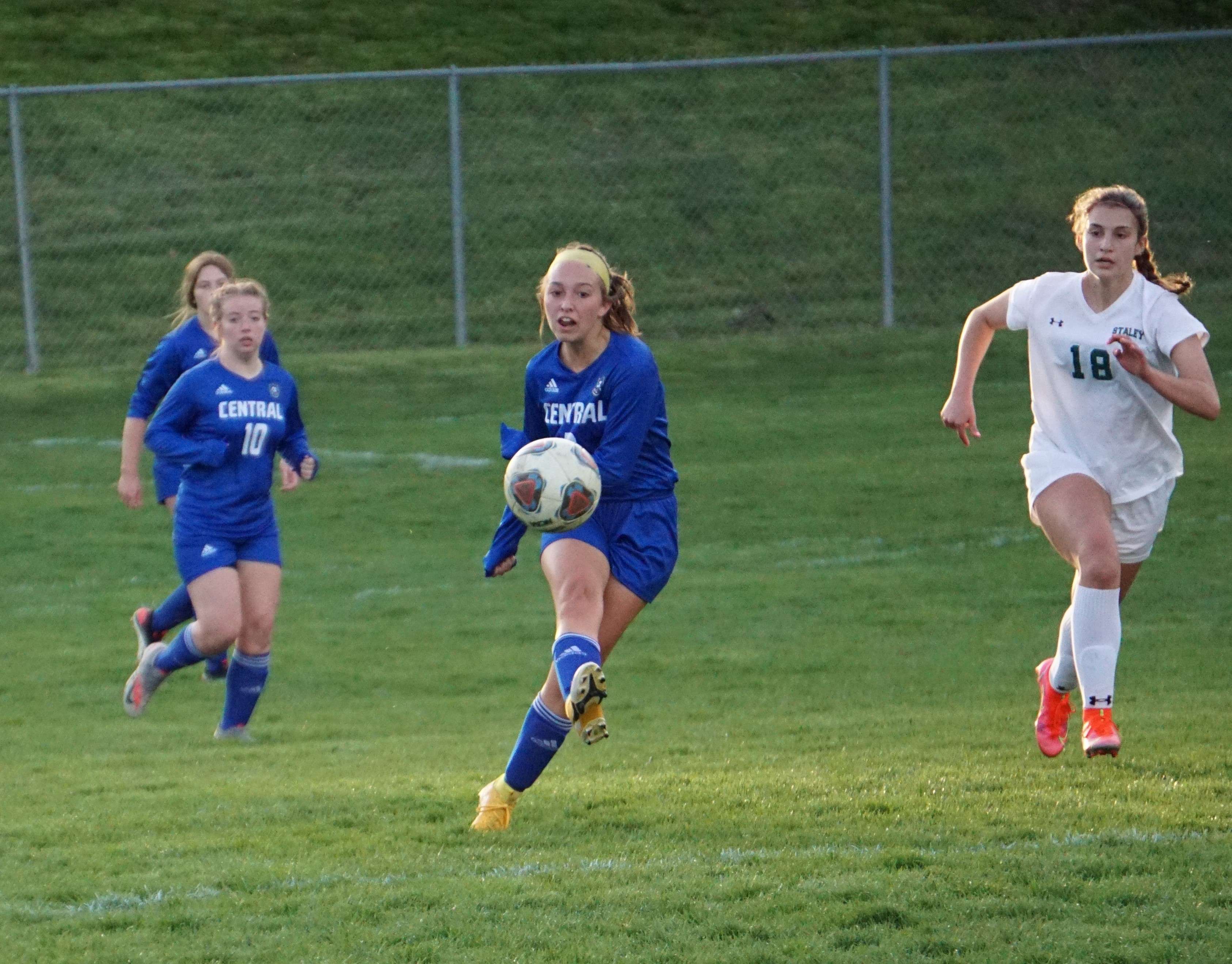 Brooklyn Dickens kicks the ball up the pitch during St. Joseph Central's match with Staley Thursday. Photo by Tommy Rezac.