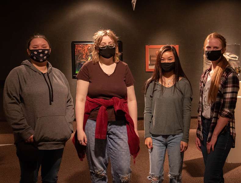 Chadron State College students whose work placed in the juried All-Student Show pose April 23, 2021, in Memorial Hall's Main Gallery. From left, Baylie Her Many Horses of Oelrichs, S.D., honorable mention, Devin Hodges of Hulett, Wyo., second place, Mia MacDonald of Cheyenne, Wyo., honorable mention, and Carissa Hill of Imperial, Neb., first and third place. (Tena L. Cook/Chadron State College)