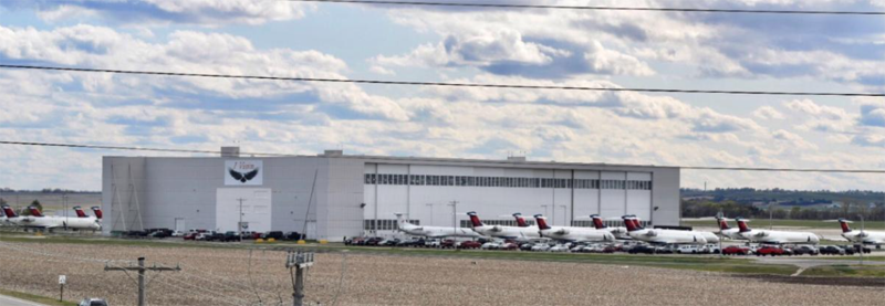 <b>1 Vision overflows Big Bertha (Hangar H959) at Salina Regional Airport.</b> Photo courtesy Salina Airport Authority