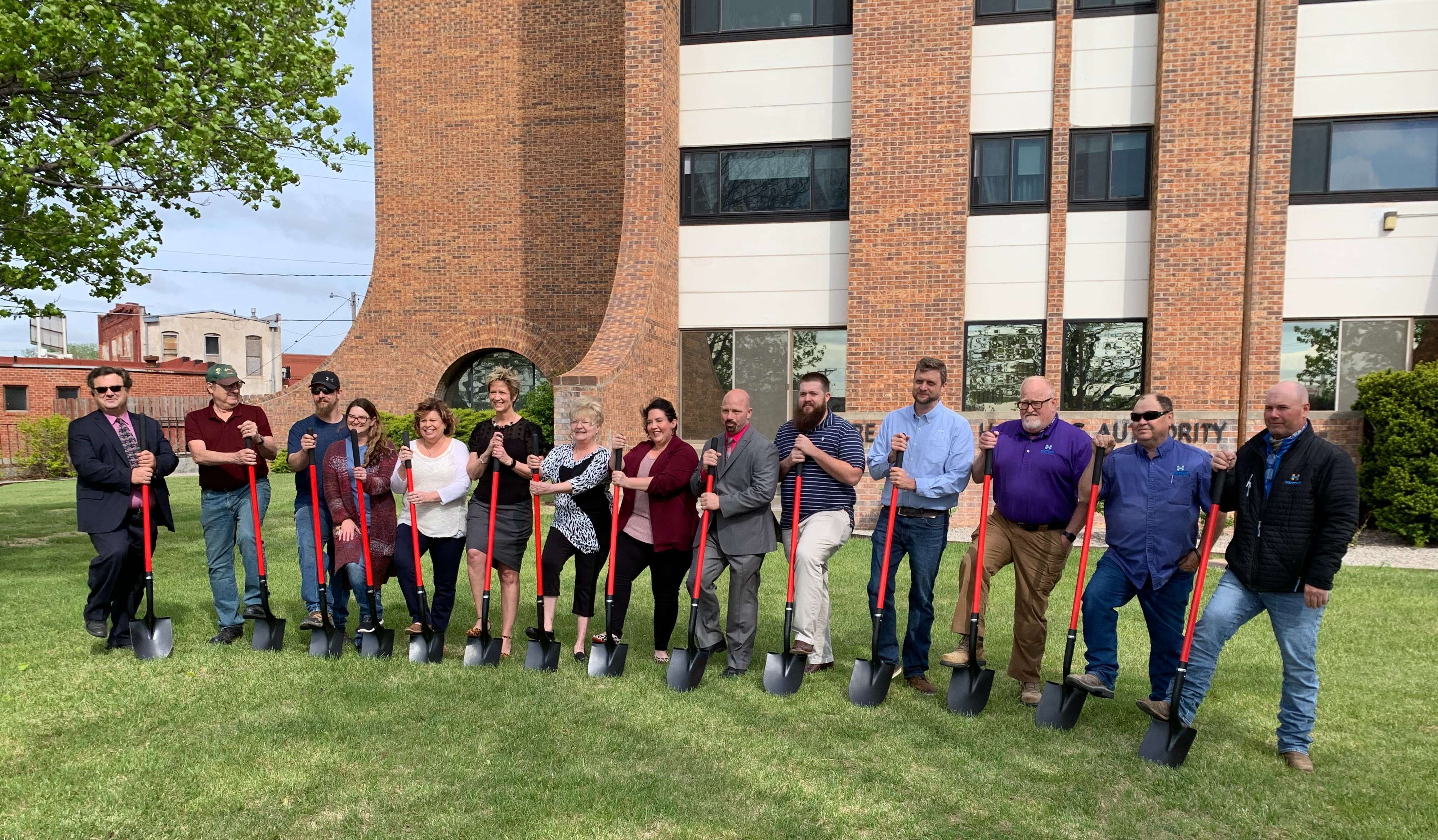 Lynn Fleming (6th from left) leads ceremony for High Rise renovation project