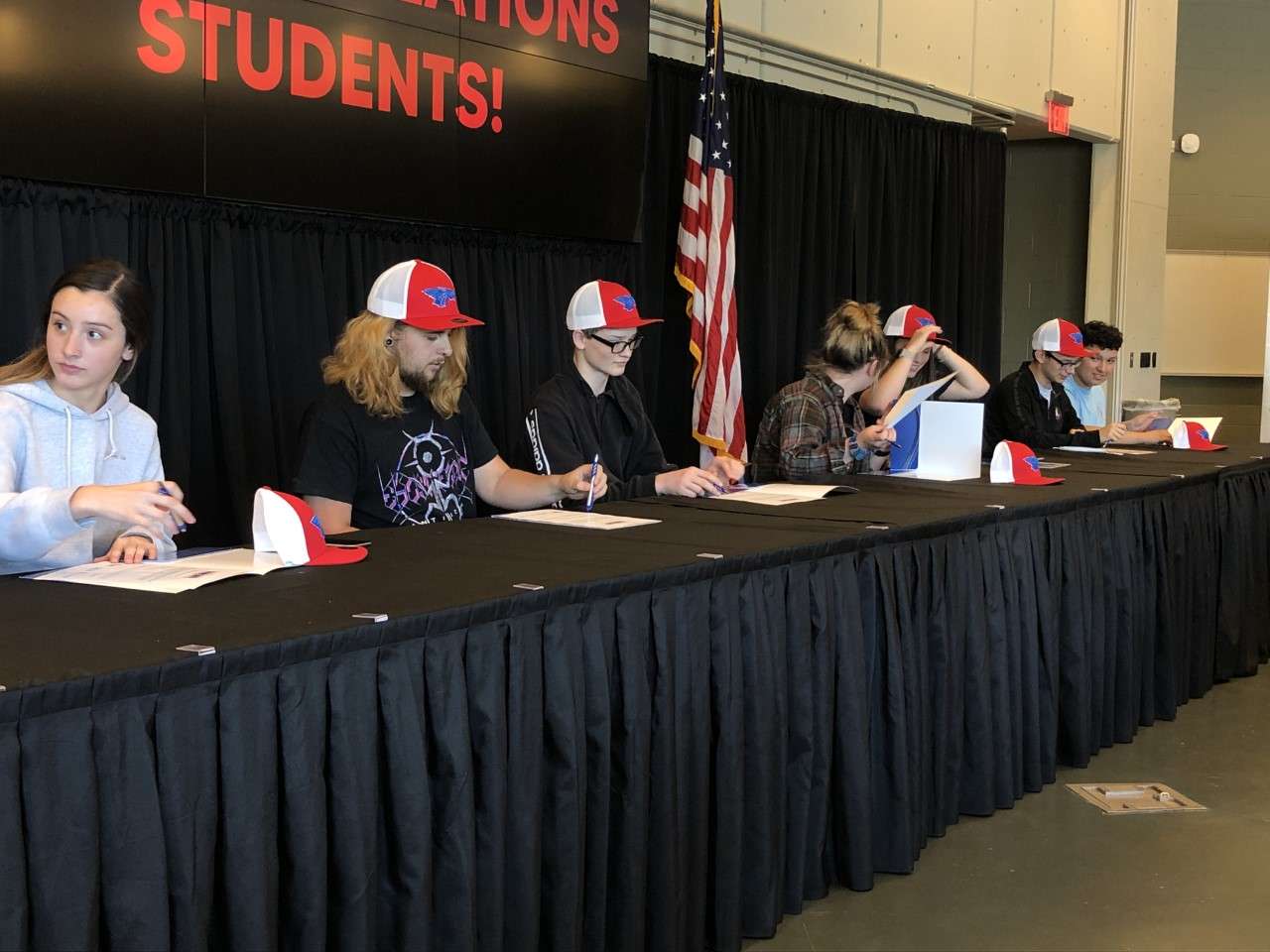 Students take turns signing their career letter of intent during the first-ever Career Signing Day.