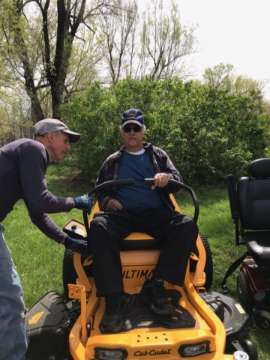 <b>Fink prepares to take a ride on his mower.</b>