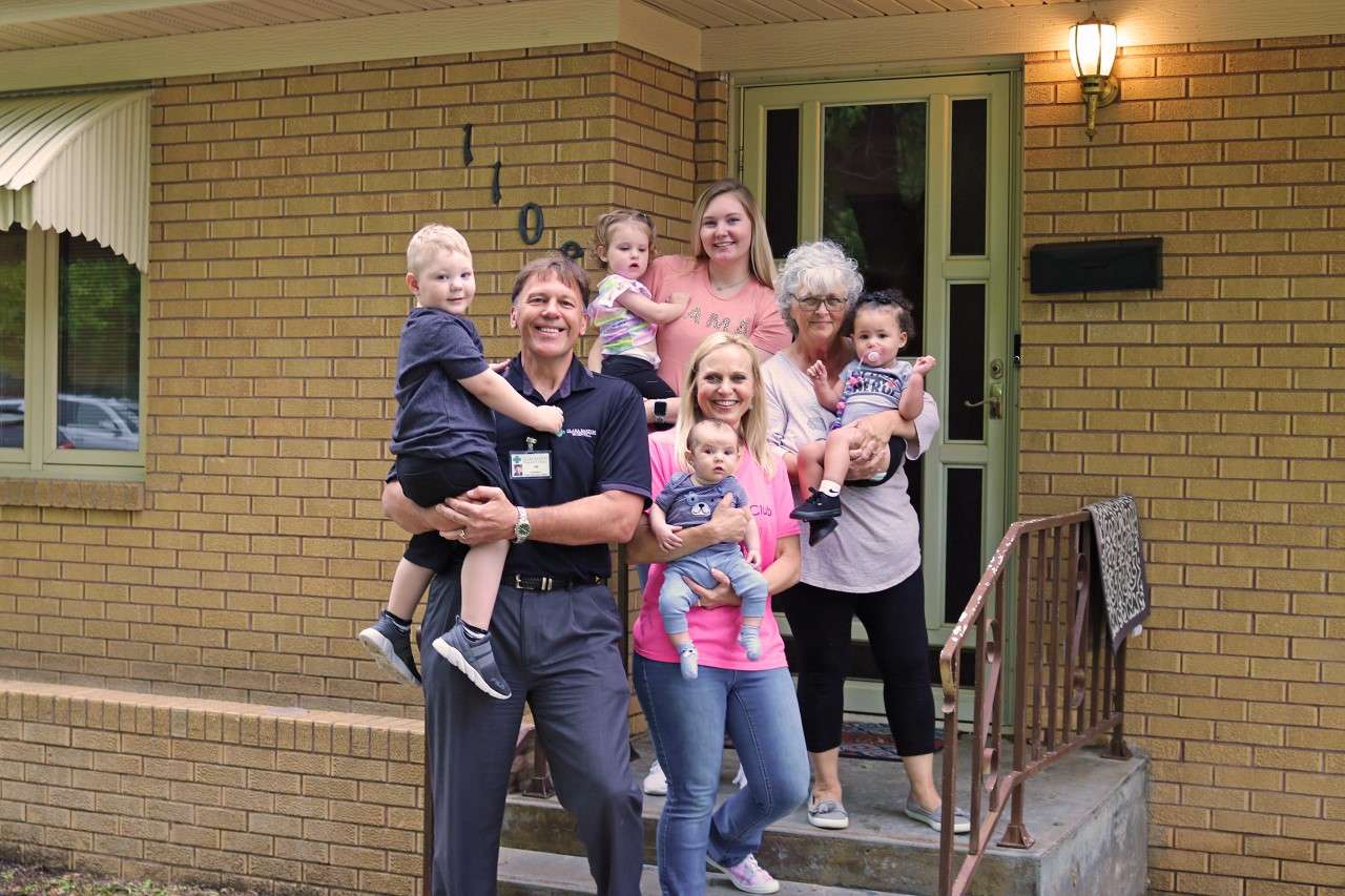 Clara Barton Hospital President &amp; CEO&nbsp; Jim Blackwell with GPS Kids Club Program Administrator Debbie Stephens and her staff in front of the new daycare house