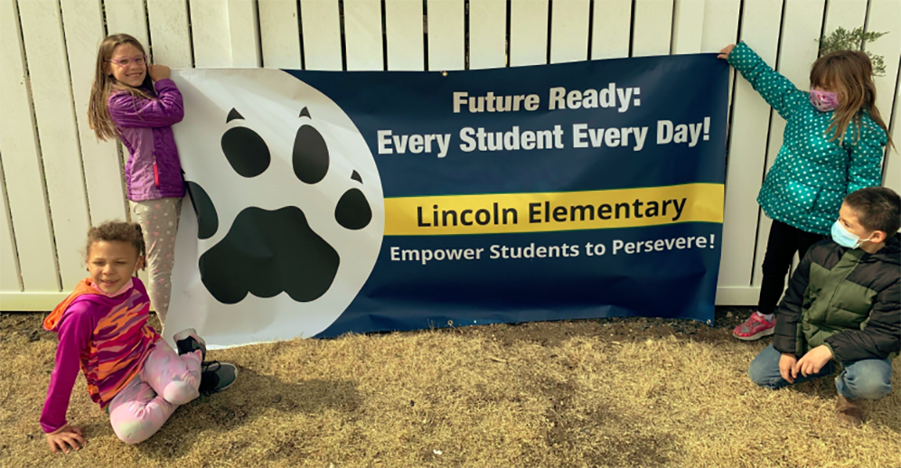 Lincoln Elementary School students hold a banner promoting the school's redesign project. Courtesy photo