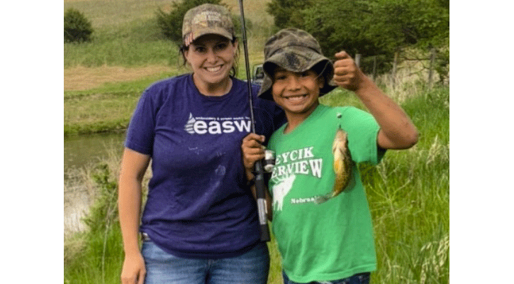 Mentoring a new angler is rewarded with a smile any time a fish is caught. (Courtesy to Nebraska Game and Parks Commission)
