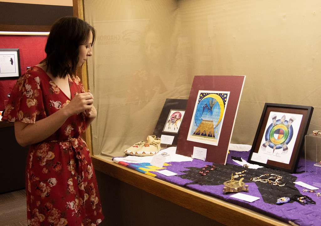 Dallas Magnusson, accounting clerk II, views Lakota cultural items on display in the Mari Sandoz High Plains Heritage Center as part of Kapemni: As It Is Above, So It Is Below through Oct. 2021. (Tena L. Cook/Chadron State College)