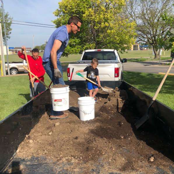 Wonder Women League volunteers load soil into a raised garden beds at Good Samaritan Society in Hays. Courtesy photo