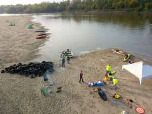 <b>Volunteers working with Friends of the Kaw make use of Kansas River sandbars for camping as well as platforms for collection and removal of tires placed years ago along the river’s edge in an unsuccessful attempt to deter erosion. (</b>Lisa Grossman)