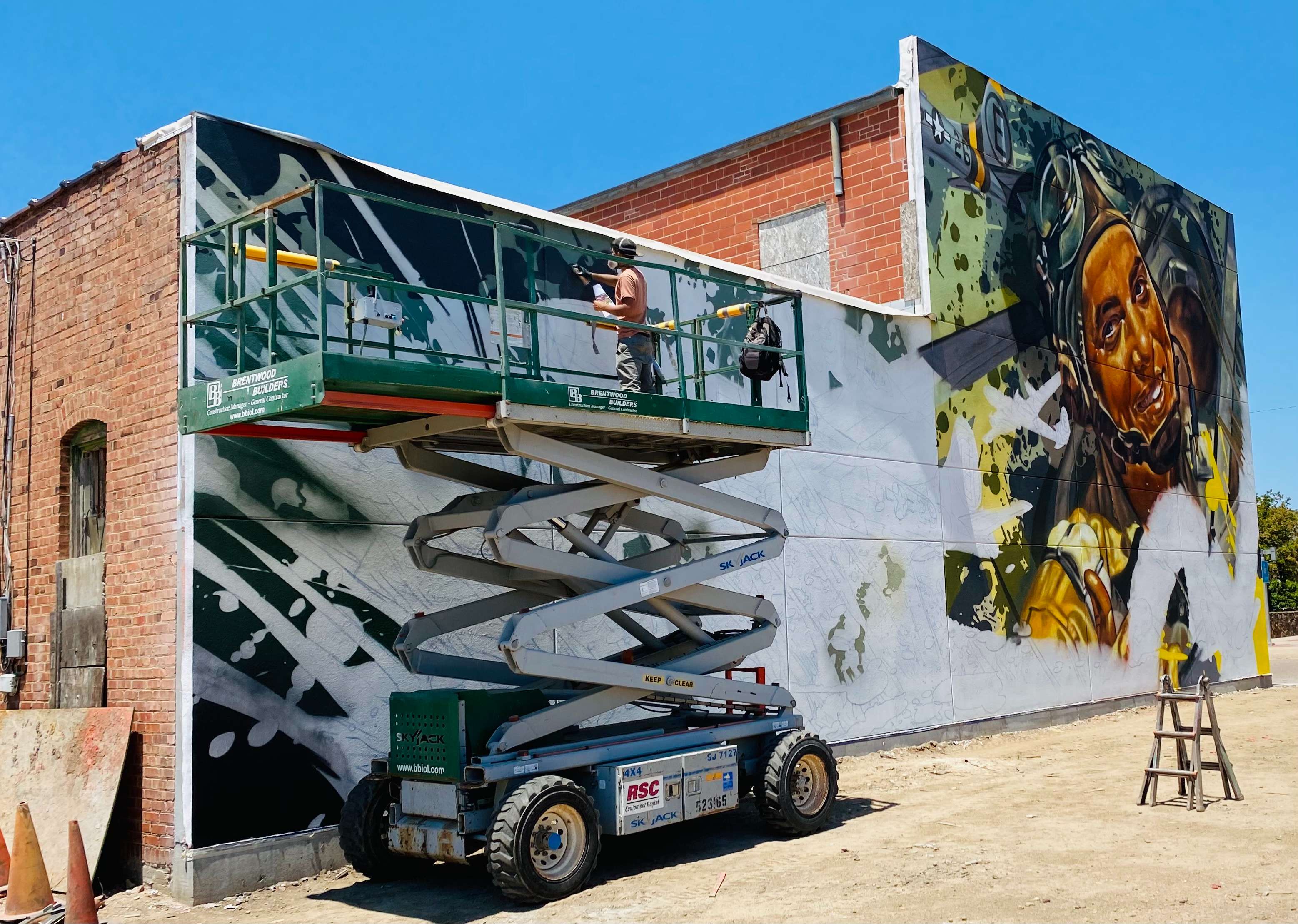 Ryan Christenson, aka ARCY, works on the mural in downtown Great Bend July 12, 2021.