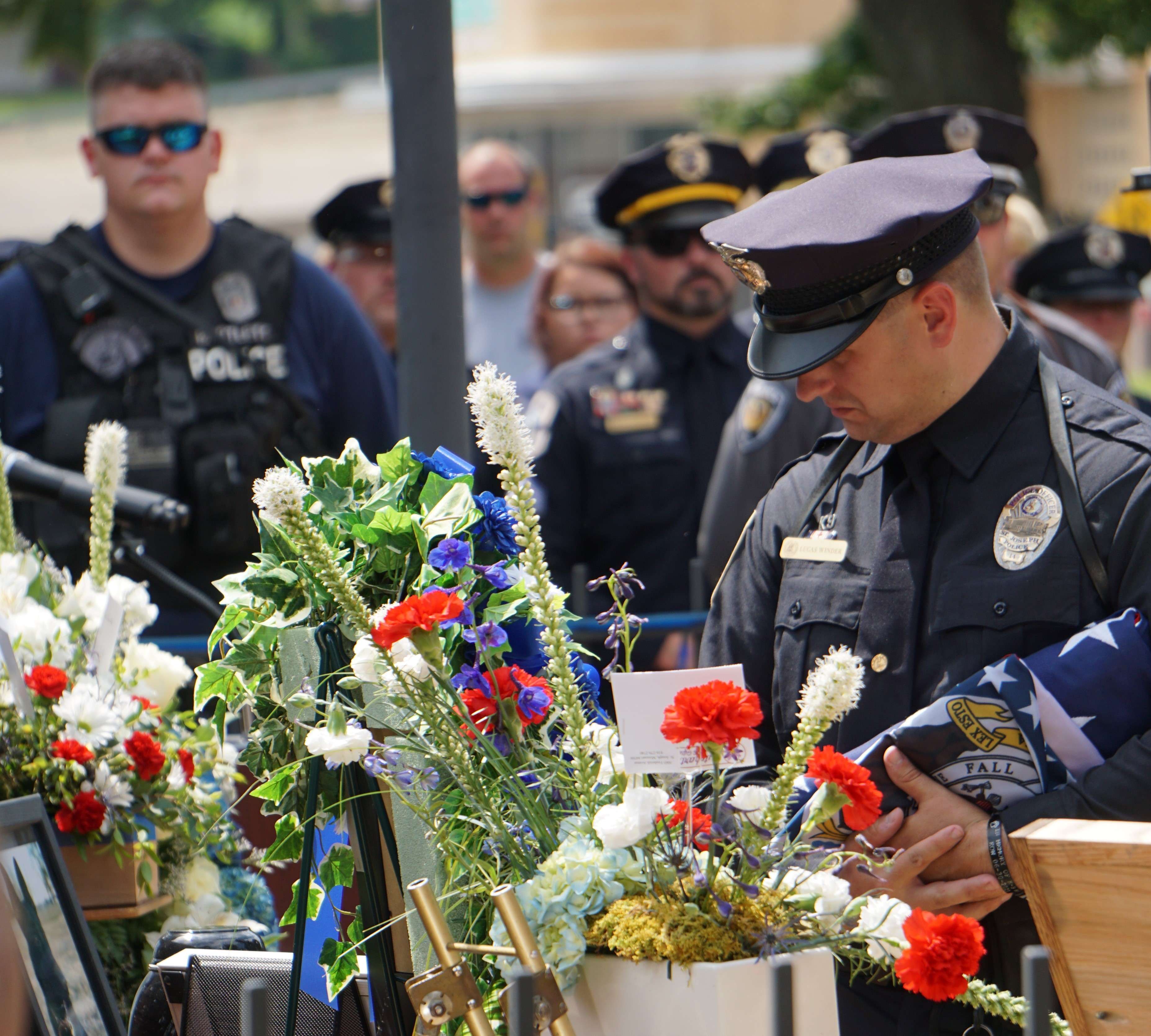 St. Joseph Police Officer Lucas Winder says goodbye to K-9 Max&nbsp; during the memorial held for the police dog at Civic Center Park/Photo by Tommy Rezac