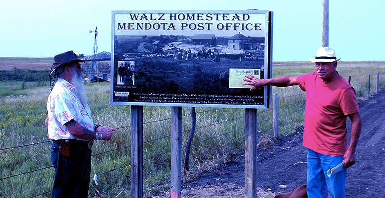 Allen Walz, left, and Leroy Walz, right, talk about a Nicodemus Trail marker at their family's homestead during a dedication of the marker in September. File photo