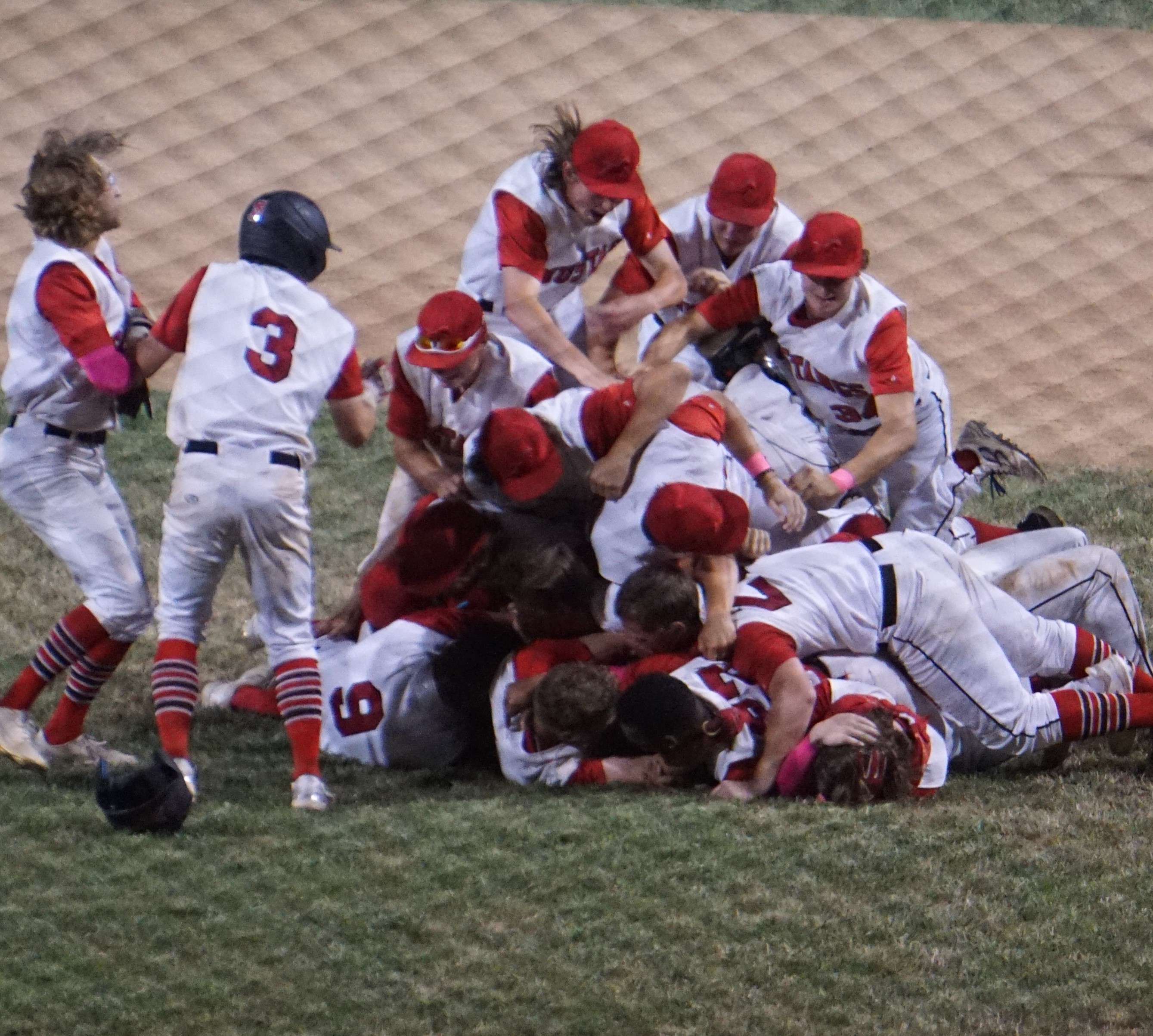 A dog pile ensues after the Mustangs beat Sedalia 12-2 for a MINK League title on Friday. Photo by Tommy Rezac.