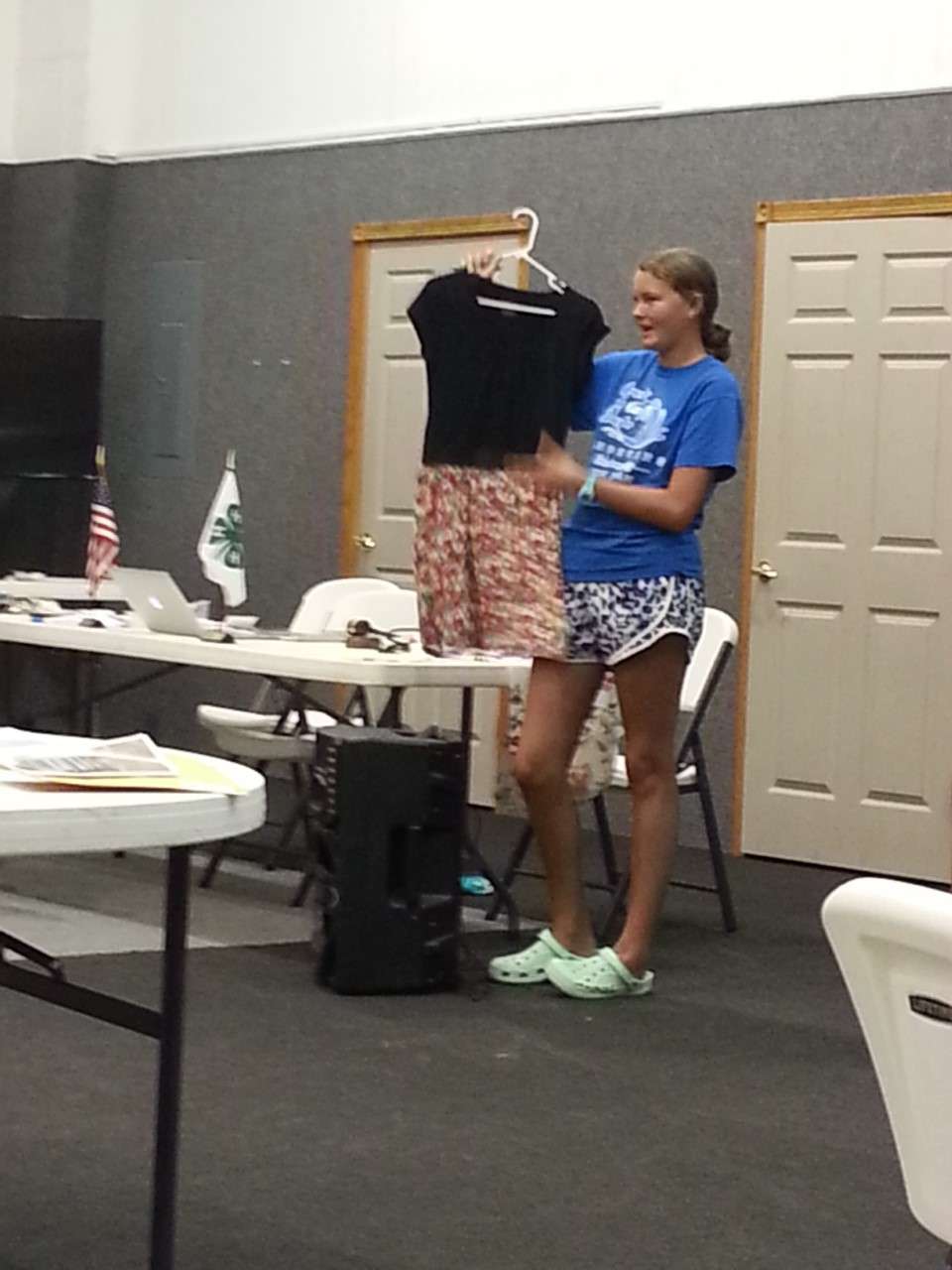 <b>Hensli Lofdahl presents her dress to the other members of the Smoky View 4-H Club during the tour.</b>