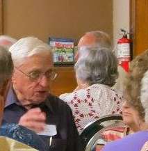 <b>Dick Brown chats with volunteers during a dinner at the Salina Senior Center in 2015.</b> Courtesy photo