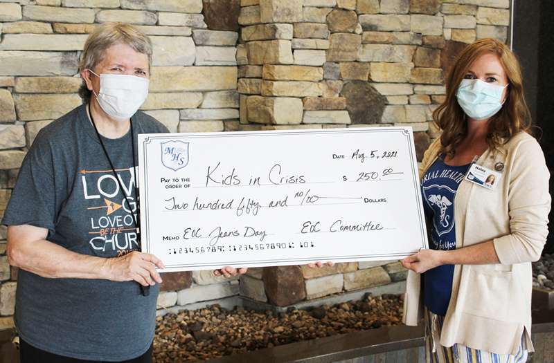 <i><b>June DeWeese, left, Kids in Crisis of Dickinson County coordinator&nbsp; accepts the check from Haley Jones, EOC committee member.</b> Photo courtesy Memorial Health System</i>