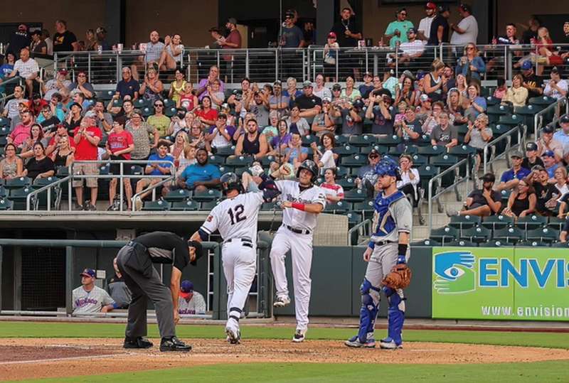 <b>The Wind Surge's Trey Cabbage and Roy Morales celebrate at home plate Friday night.</b> Photo courtesy Wichita Wind Surge