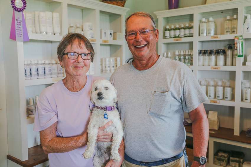 <b>Dianne and Mike stand in their on-farm lavender shop with their dog, Augie.</b>