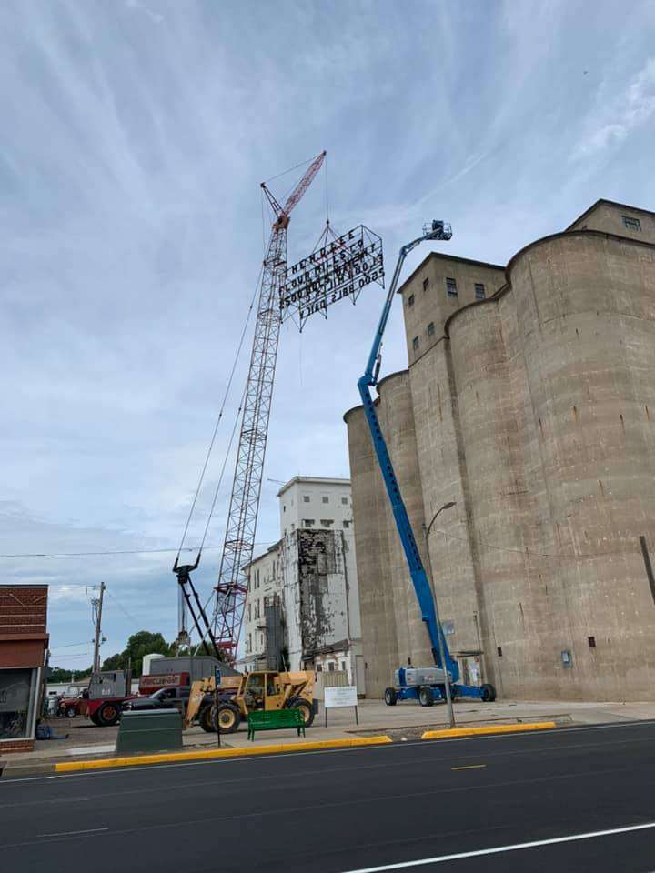 <b>A crane removes the sign from the old mill.</b> Photo courtesy Tanner Colvin/ Vortex Companies