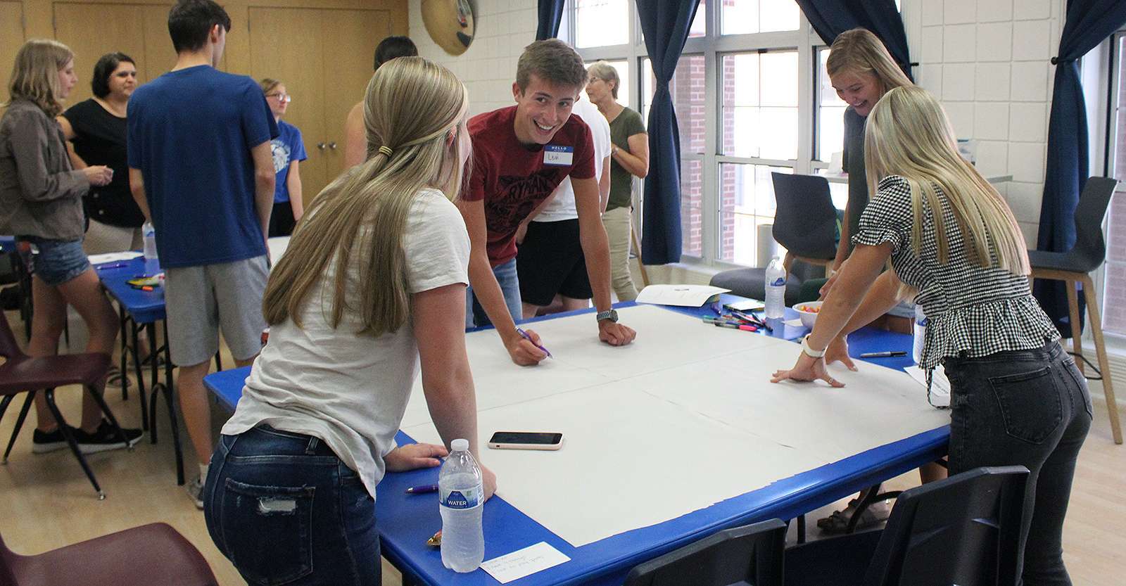 Levi Huser discusses important places and organizations in Ellis County with fellow teens (from left) Shelby Schmeidler, Kaitlyn Windholz and Melany Huser during the Heartland Community Foundation Teen Talk event Wednesday.