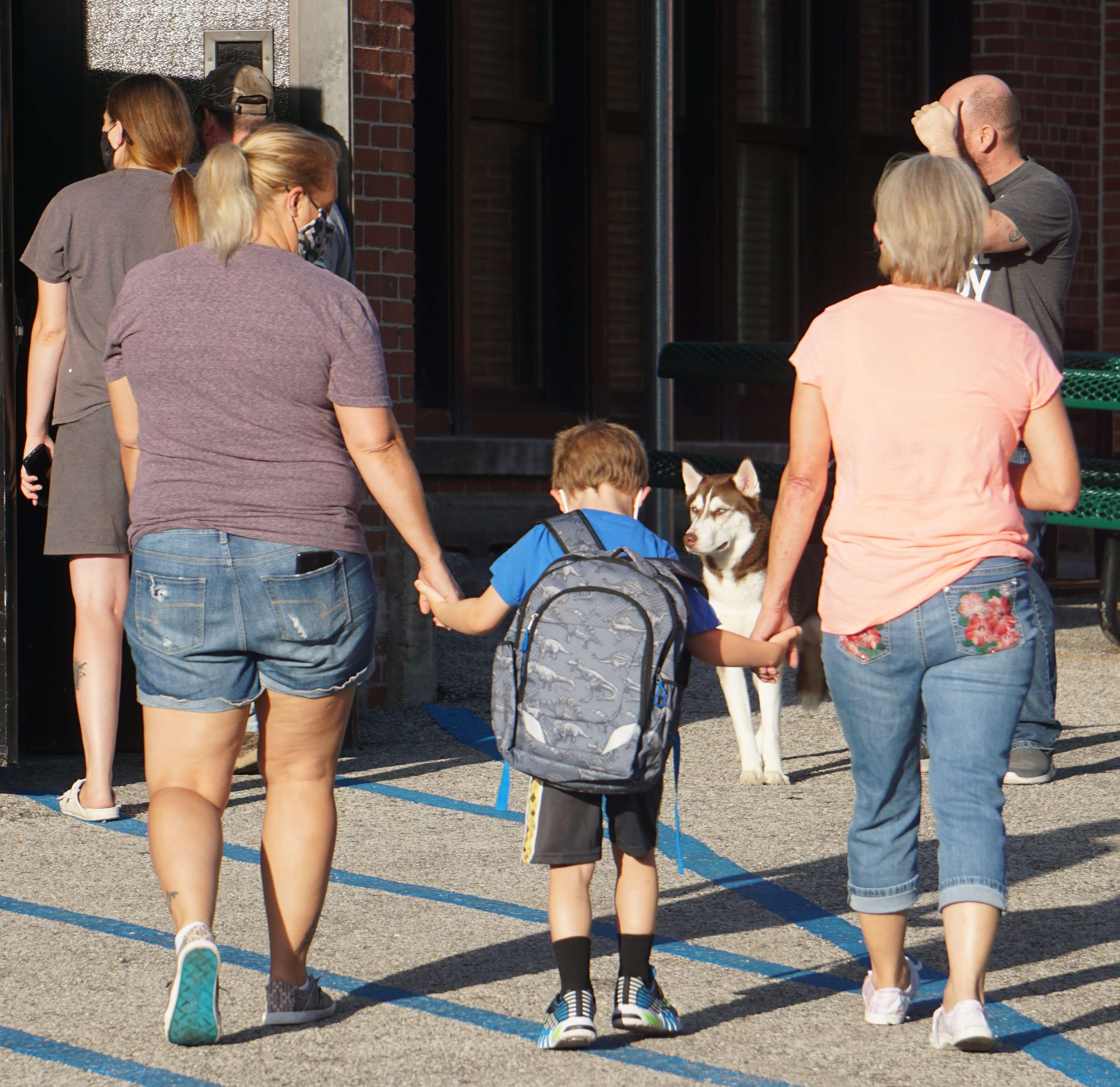 Parents escort children to Lindbergh Elementary School in St. Joseph Monday as another school year starts. Photo by Tommy Rezac.