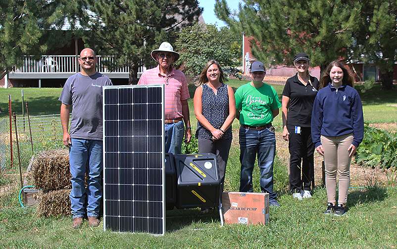 From left, Nolan Schmeidler, operations maintenance manager at Buckeye Wind Energy; Randy Brull, TMP garden coordinator; Melissa Pinkney, TMP garden coordinator; Preston Mermis, TMP eighth-grader and garden volunteer; Lesa Lang-Parson administrative assistant Buckeye Wind Energy; and Jenna Brull, TMP eighth-grader and garden volunteer; receive donations for the TMP garden from Invenergy last week. Cristina Janney/Hays Post