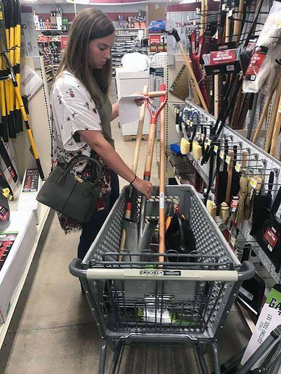 Nikole Winter, Hays High School ag teacher, picks out garden tools that were purchased through a donation from Invenergy. Courtesy photo