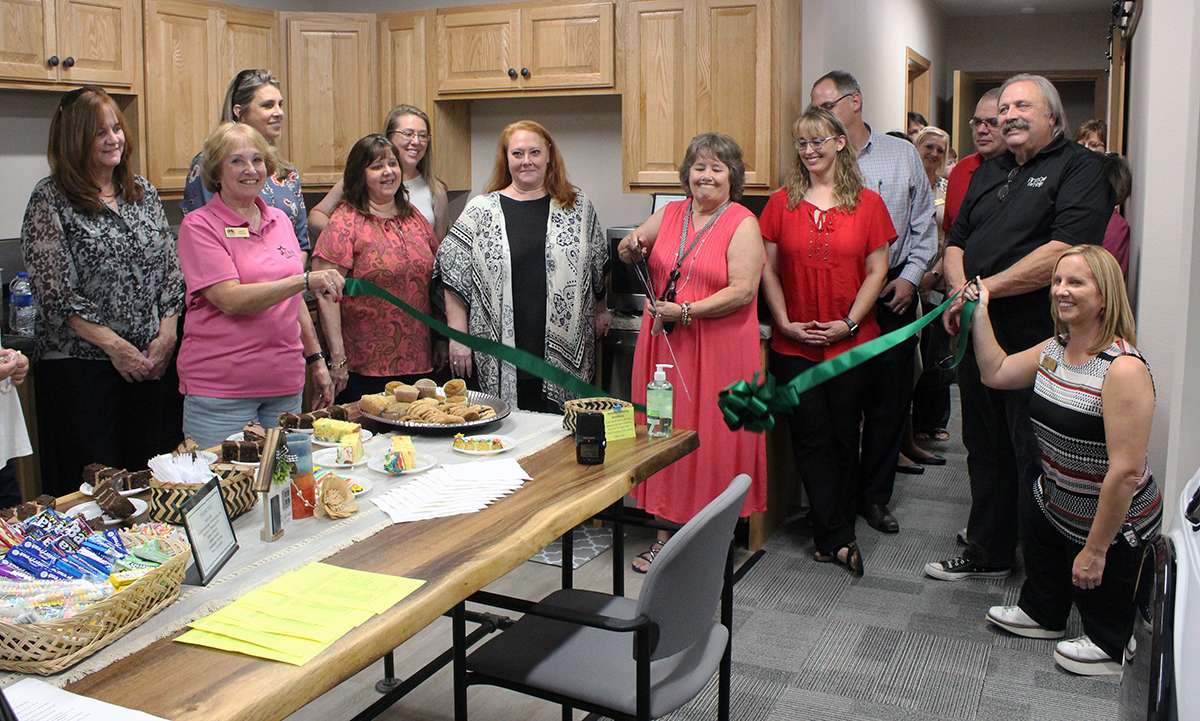 From left: Jayne Inlow, Hays Chamber; Marie Froelich, Chamber ambassador and Wonder Women League member; Sarah-Renee Moritz, Hays Chamber ambassador and Wonder Women League member; Laura Shoaff, First Call for Help office assistant/program coordinator; Sarah Wasinger, Hays Chamber president/CEO; Laura Allen, First Call for Help client services specialist; Linda Mills, First Call for Help executive director; Terri Braun, First Call for Help board member; Dennis Wilson,&nbsp;First Call for Help board member; and Callie&nbsp;Kolacny, Chamber ambassador; cut a ribbon Tuesday on the First Step Housing Project at&nbsp;607 E. 13th St. The program will help Ellis County residents who are facing homelessness.