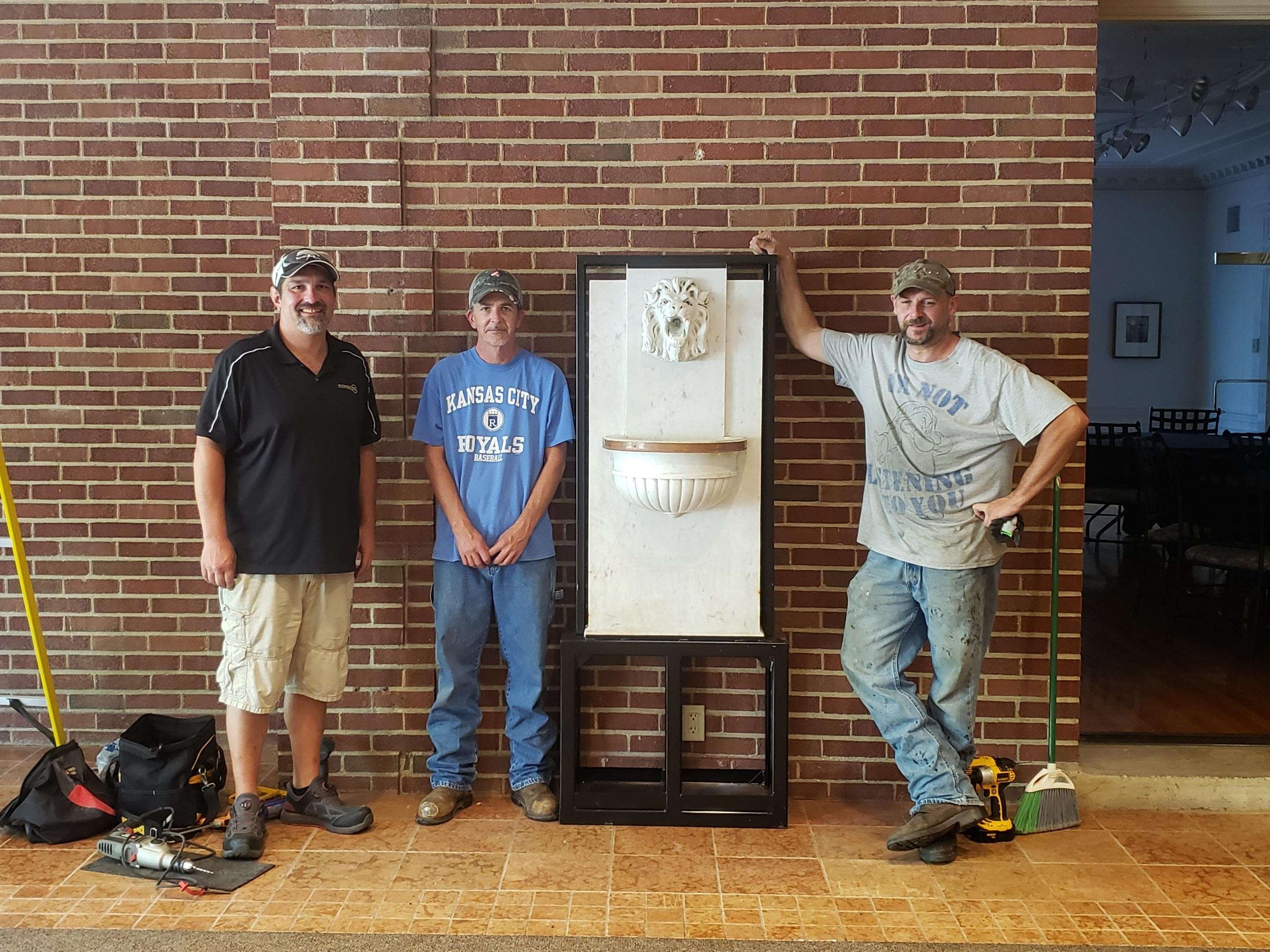 Sunshine Electronic Display workers with the fountain at the museum.