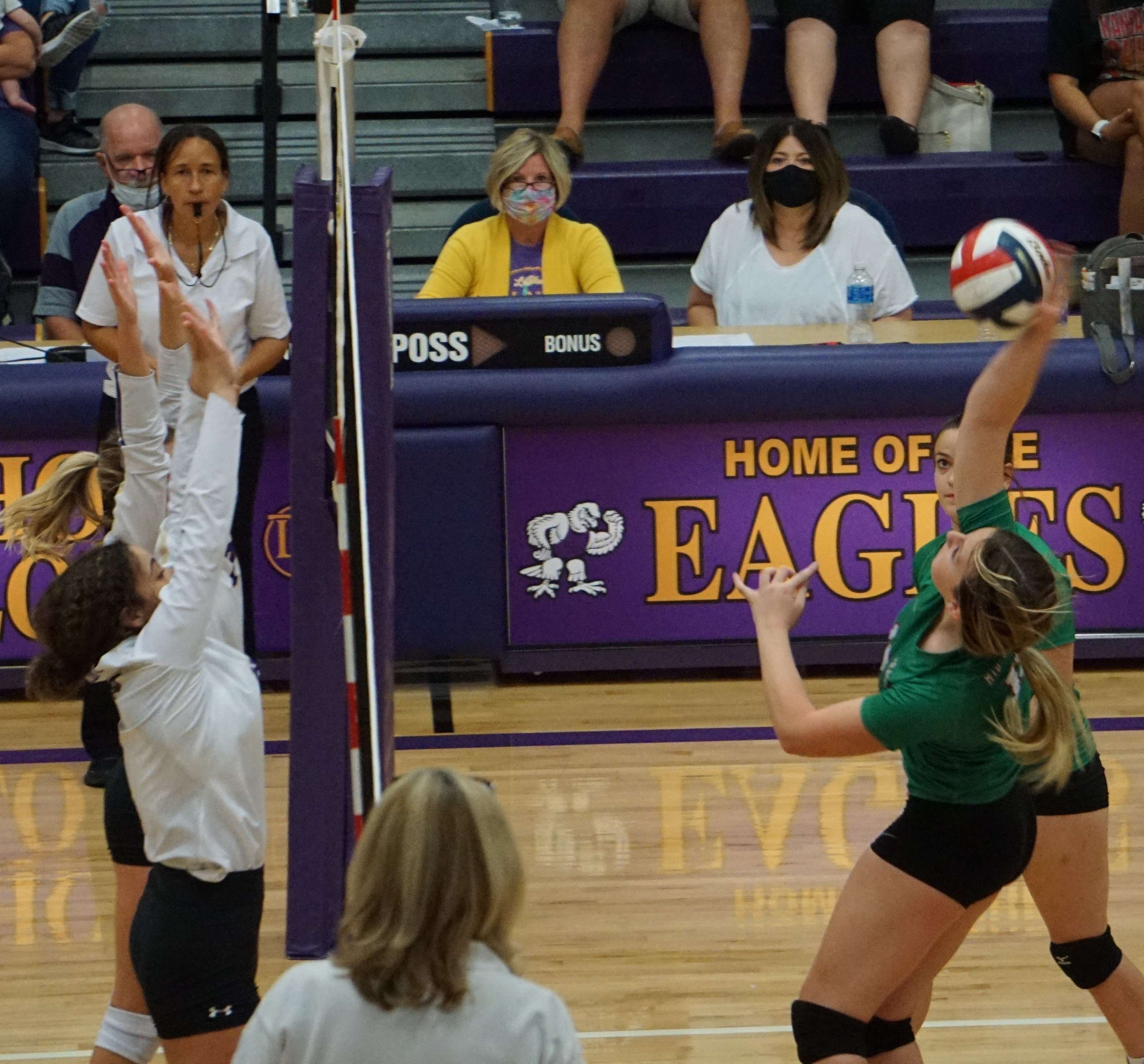 Mallie Lieffring (right) tries to hit one past the LeBlond blockers in the third set. Photo by Tommy Rezac.