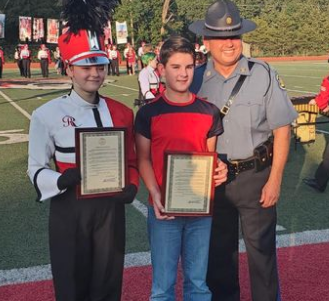 Tandon Baker and Emilee Williams receiving a Proclamation of Recognition from Governor Mike Parsons as well as an Honorary Trooper Award issued from the Superintendent of the Missouri Highway Patrol Colonel Eric Olson Presented by Captain Eddie Blaylock Commanding Officer of Troop I for their heroic actions-photo courtesy St. James R-1 Schools 