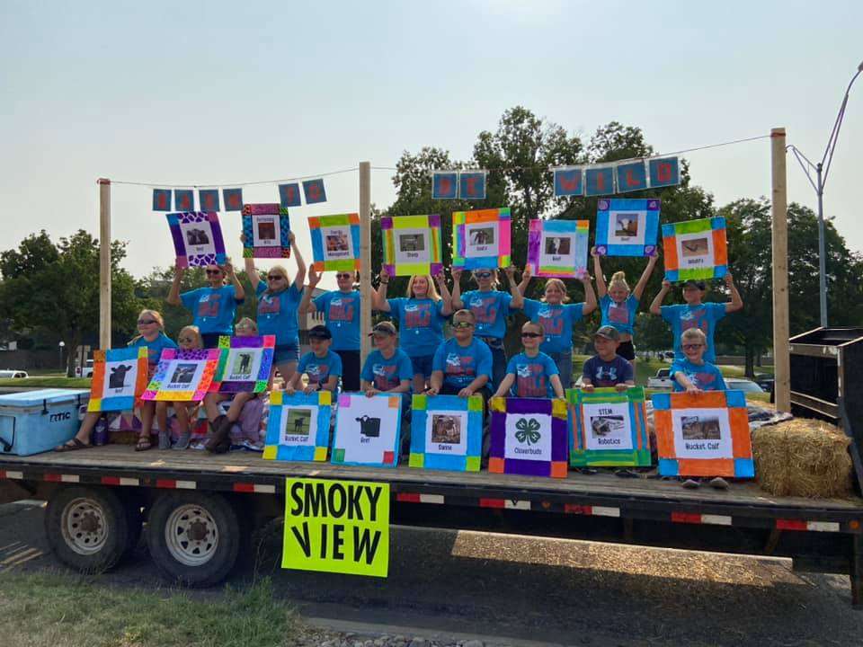 <b>Smoky View 4-H Club members rode on the float they decorated in the Tri-Rivers Fair parade on Aug. 3. Members created wild barn quilts that showed their favorite projects to go with the fair theme Barn to be Wild. The Smoky View float won first place.</b> Photo courtesy Smoky View 4-H Club