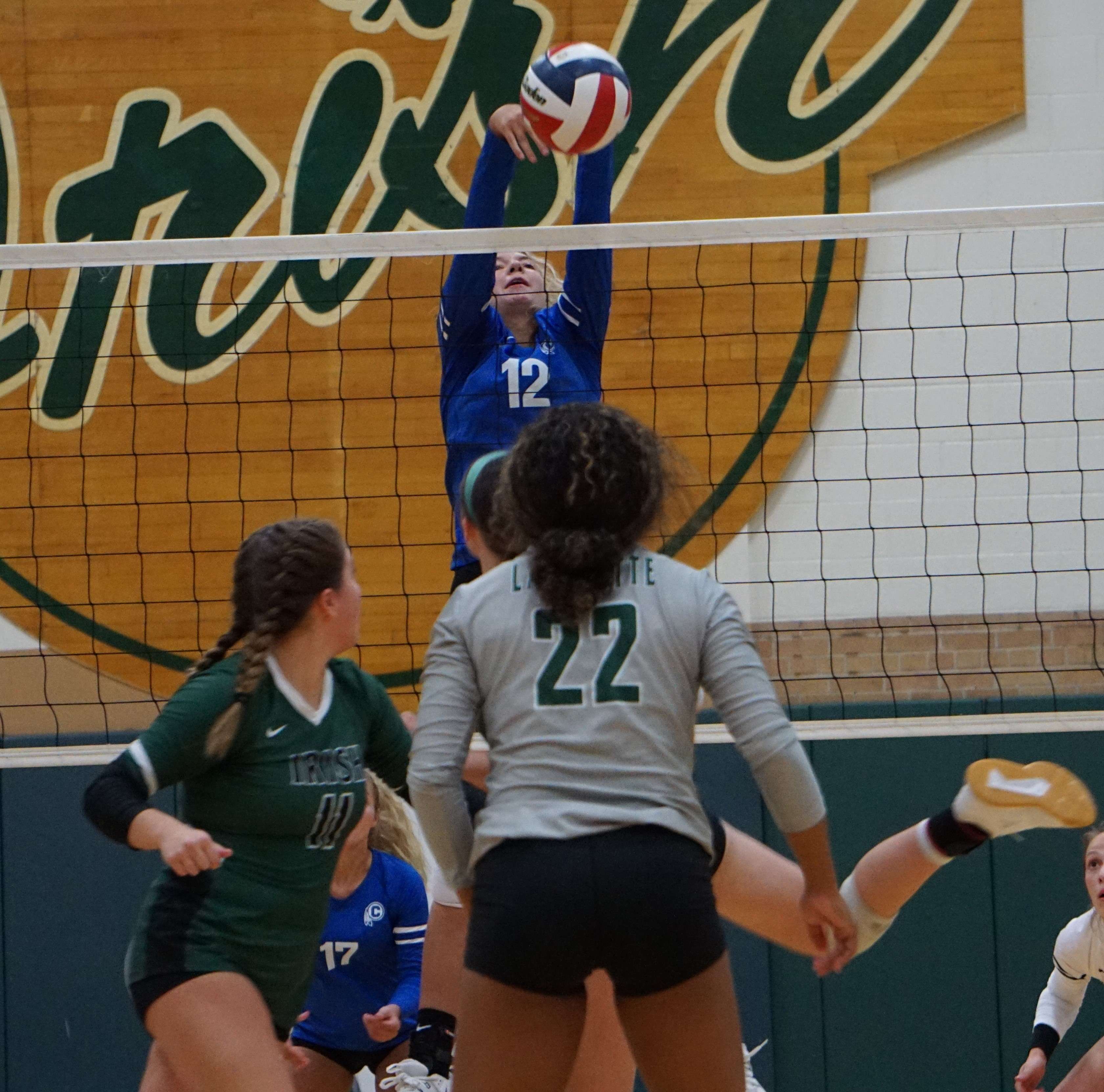 Central's Katie Miller (12) throws a block against Lafayette in Wednesday's match. Photo by Tommy Rezac.