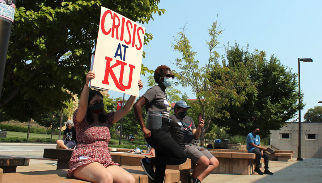 Students, faculty and staff members rally Sunday at Wescoe Beach on the University of Kansas campus to call on administrators to impose a vaccine mandate on campus. (Lucy Peterson for Kansas Reflector)