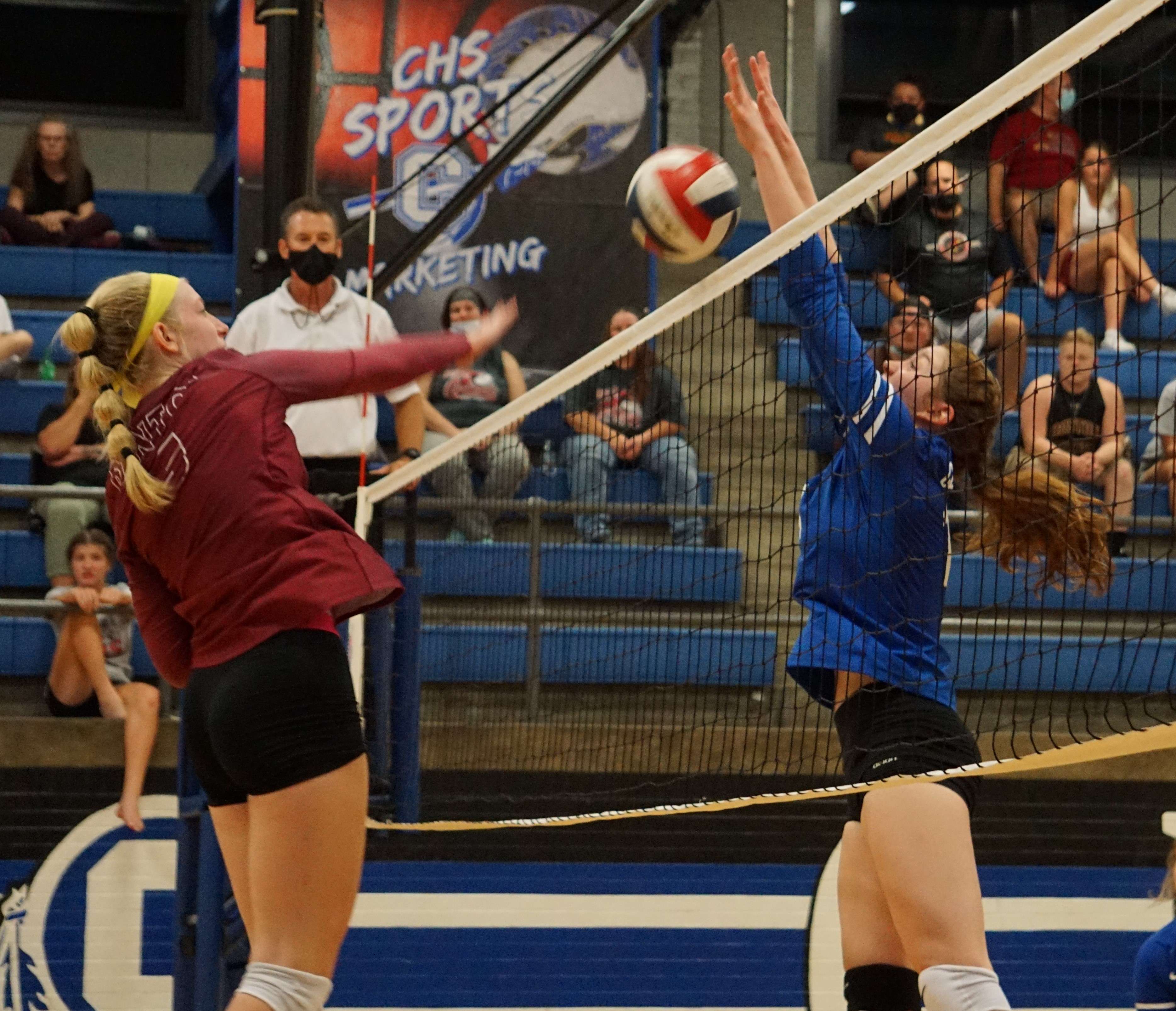 Central's Isabella Flaska (right) blocks Benton's Andrea Simmons (left) in the fourth set of Monday's match. Photo by Tommy Rezac.