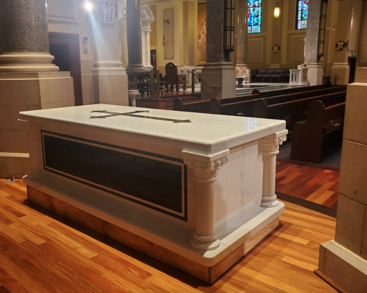 Fr. Kapaun’s 5,400 lb. marble tomb placed on the concrete foundation in the east transept of the Cathedral of the Immaculate Conception in Wichita-photo Catholic Diocese of Wichita