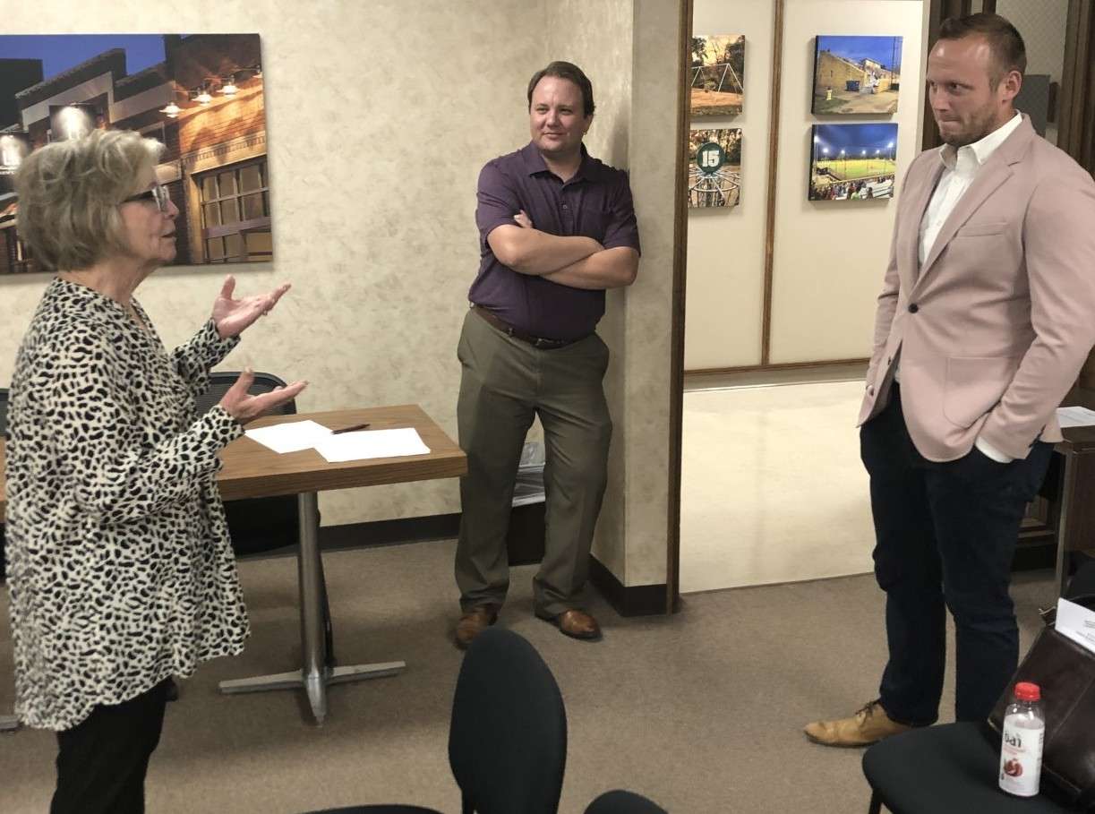 Prior to Thursday's Hays city commission work session, Mayor Sandy Jacobs and Asst. City Manager Collin Bielser visit with&nbsp; Justin Pregont (at right) about the Atchison developer's plans for renovation of the historic St. Joseph School into high-quality apartments.&nbsp;