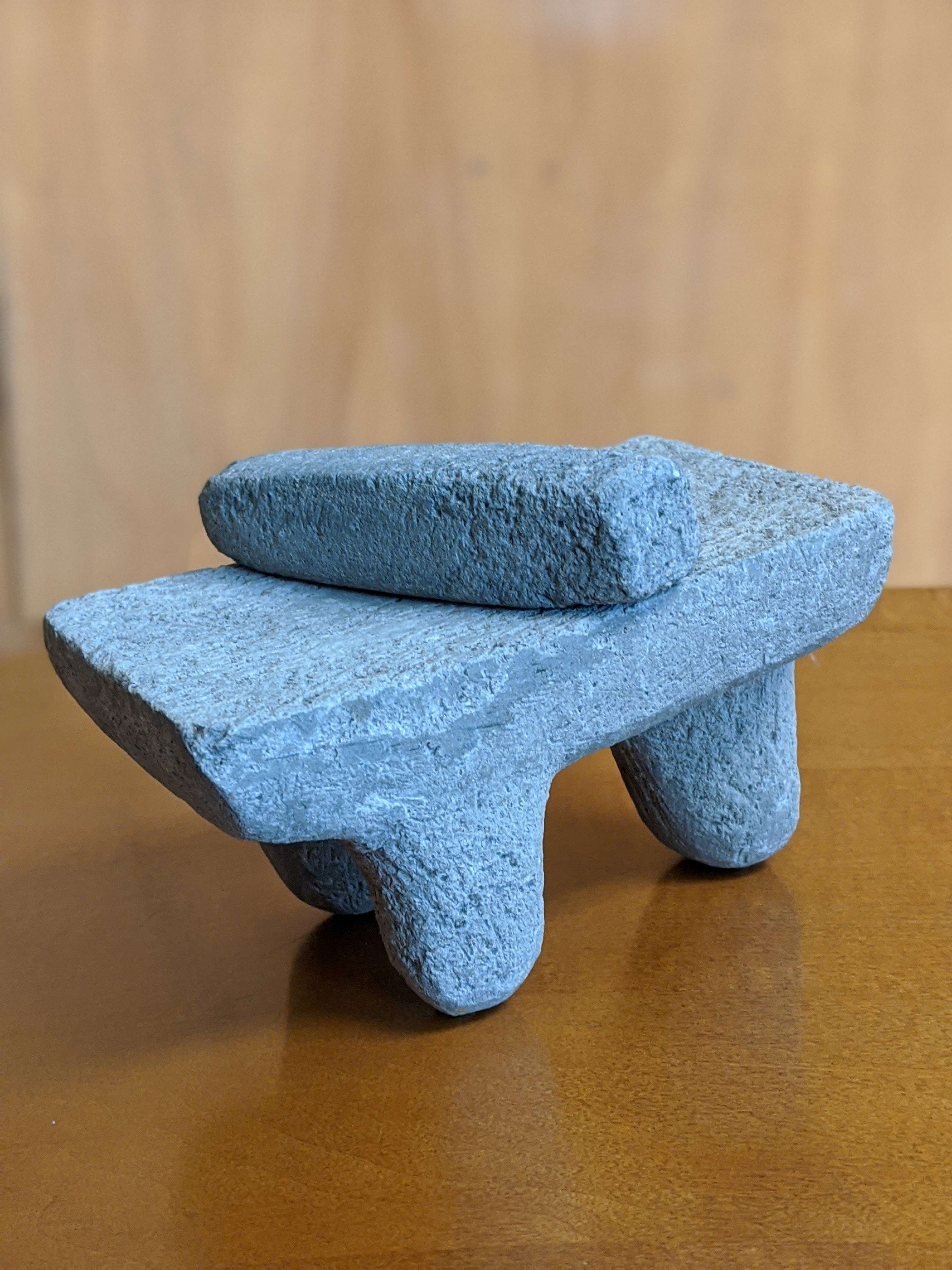 A replica metate (grinding stone) and mano (tool on top) belonging to Dr. Tawny Tibbits. Research by Tibbits analyzing the chemical properties of granite from a 1,000 B.C. Maya quarry in Belize has been published in a peer-reviewed book. (Courtesy image used with permission)   